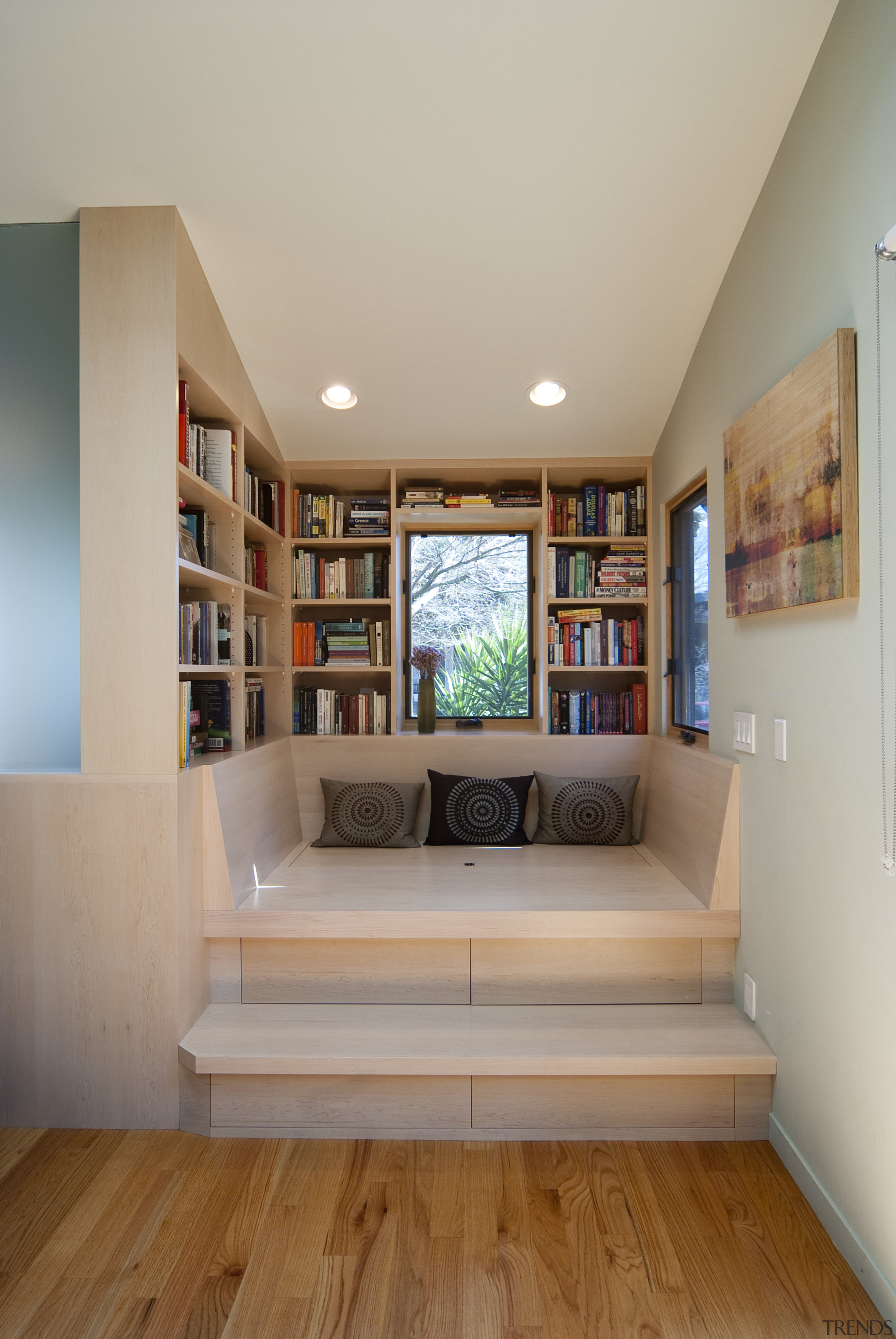 Inset seating area with shelves. - Inset seating bookcase, ceiling, floor, flooring, furniture, hardwood, home, house, interior design, living room, room, shelf, shelving, table, wall, wood, gray, brown