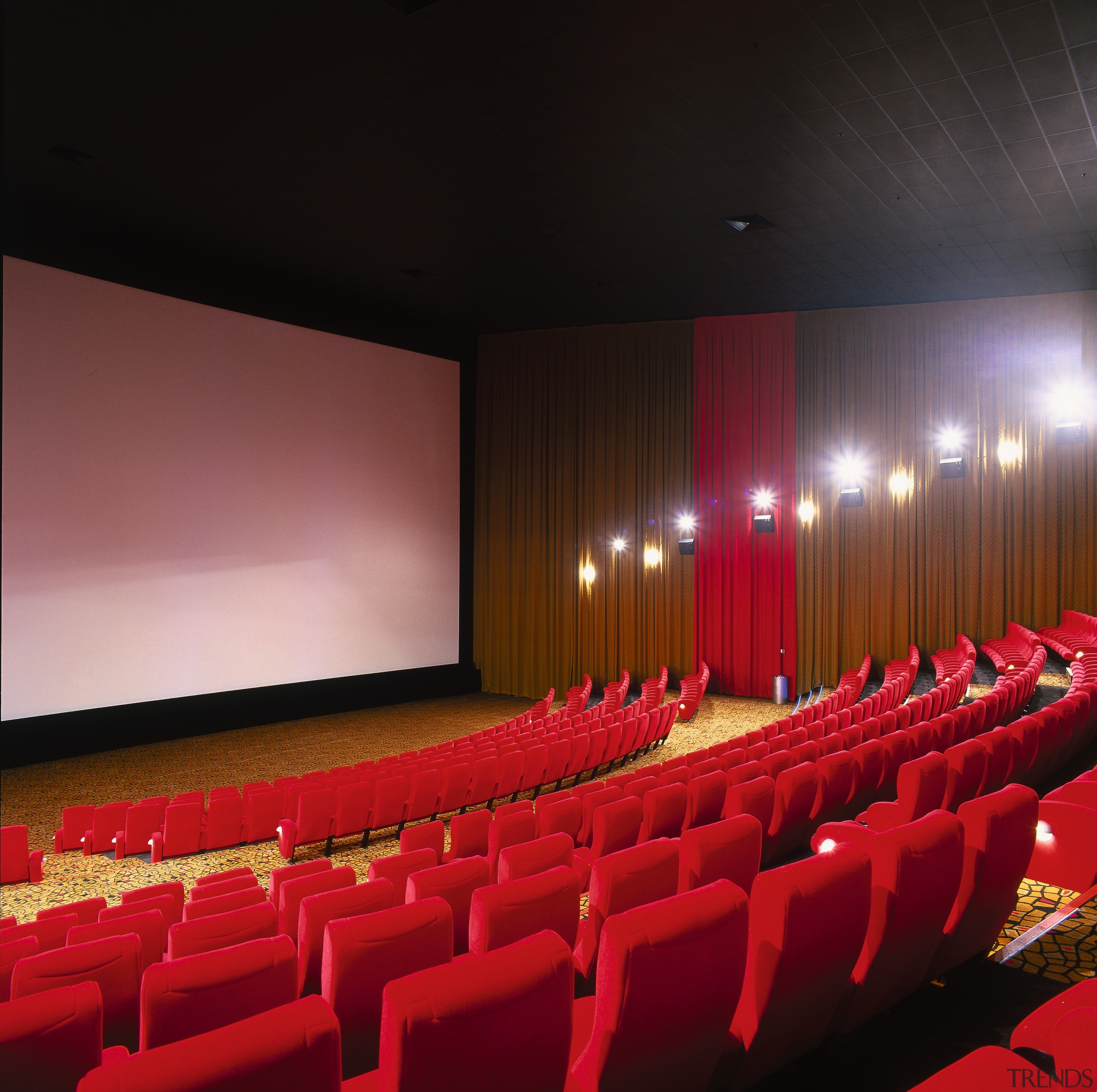 View of cinema seating area with red chairs auditorium, movie theater, performing arts center, theatre, red, black