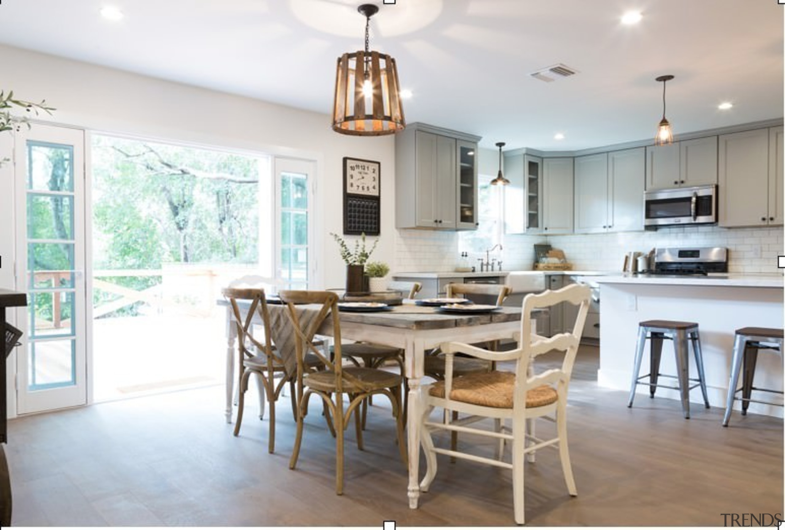 The farmhouse stylings meet more contemporary touches in chair, countertop, cuisine classique, dining room, furniture, home, interior design, kitchen, real estate, room, table, white