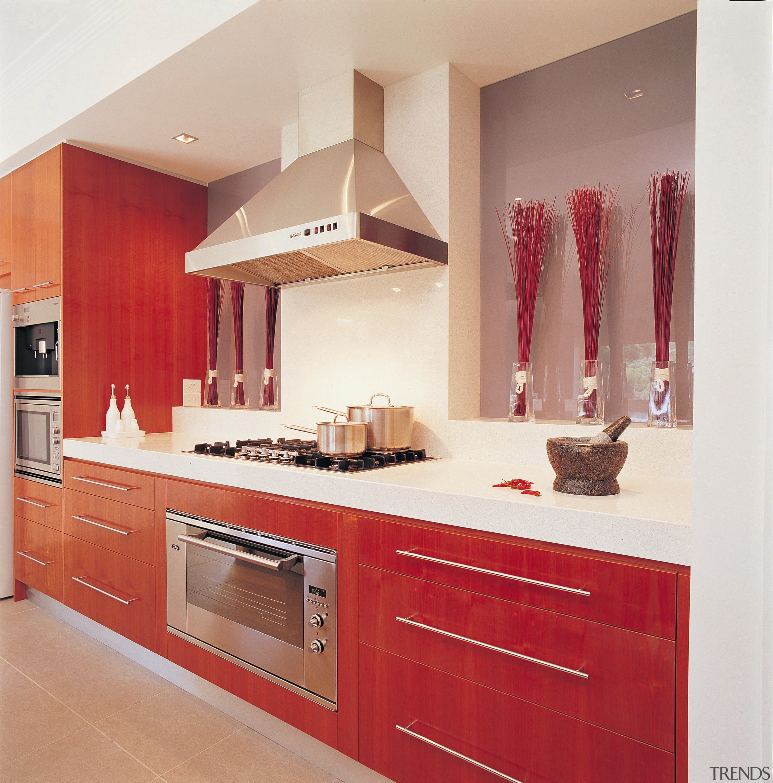 Kitchen with red toned cabinetry, white benchtop and cabinetry, countertop, cuisine classique, floor, furniture, interior design, kitchen, room, white, red