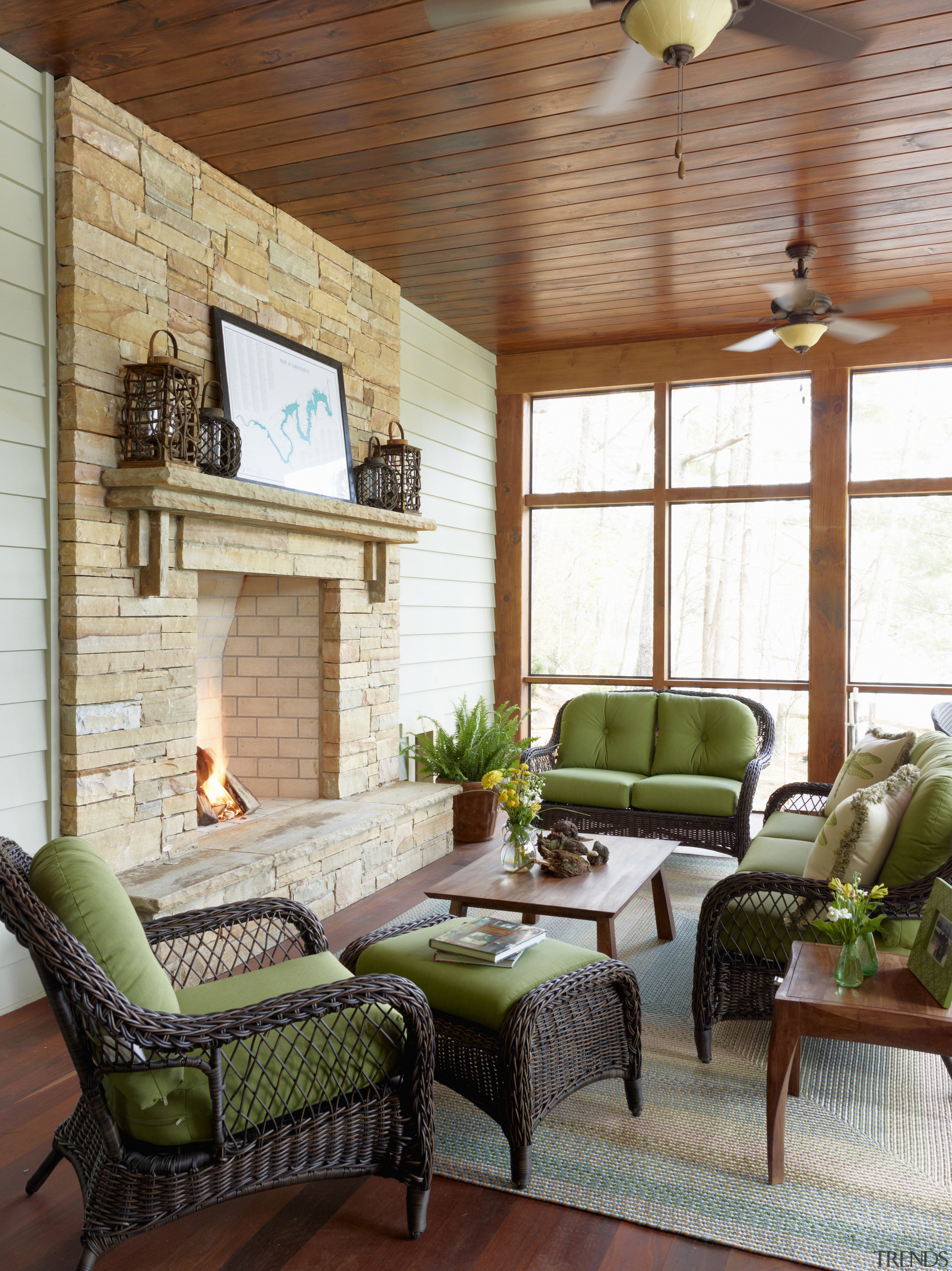 This screened porch is in a lakefront home ceiling, furniture, home, interior design, living room, outdoor structure, porch, wall, window, white, brown