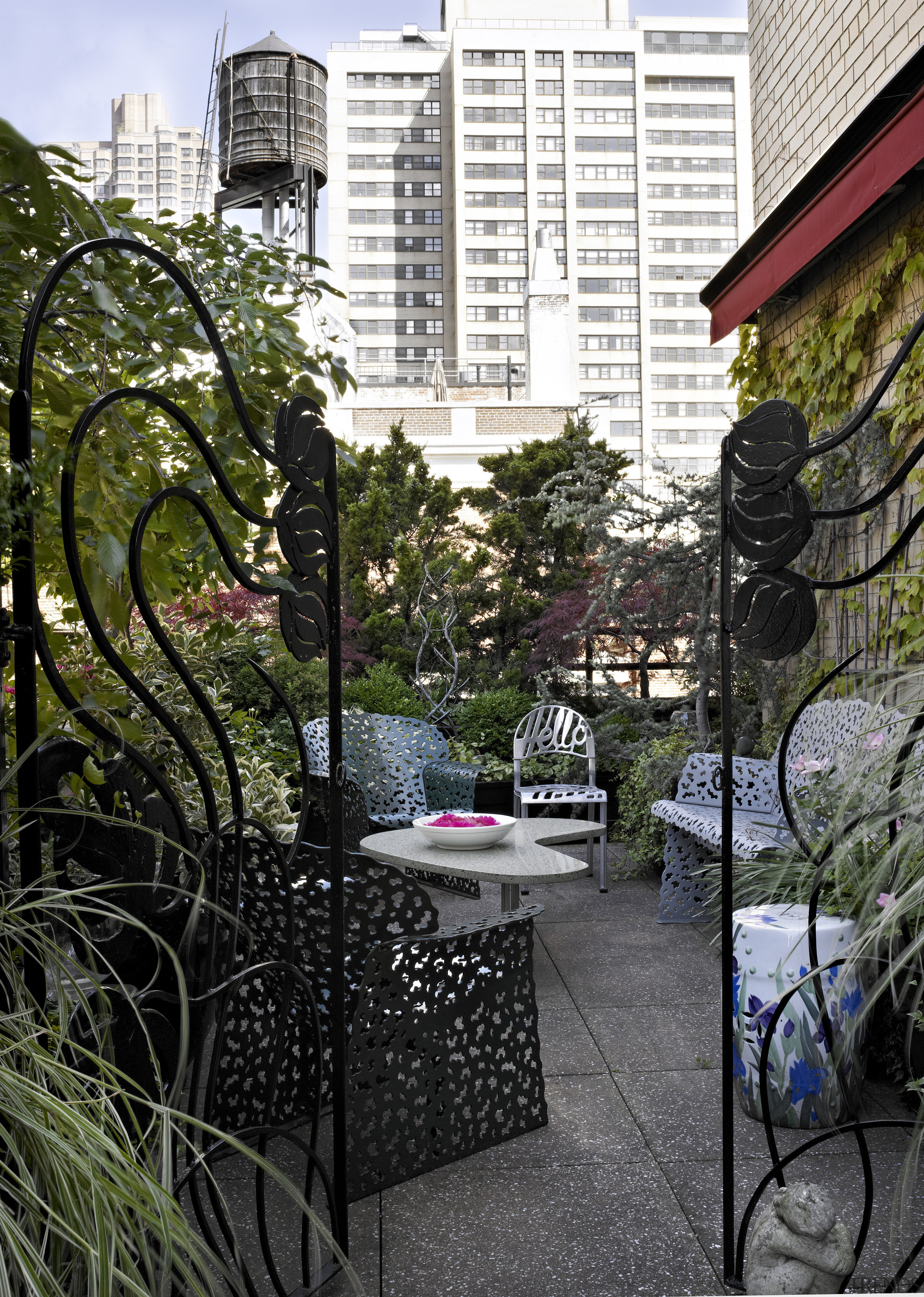 Antique steel gates acquired by the owners frame architecture, balcony, city, condominium, courtyard, garden, house, neighbourhood, outdoor structure, plant, residential area, tree, urban area, walkway, black