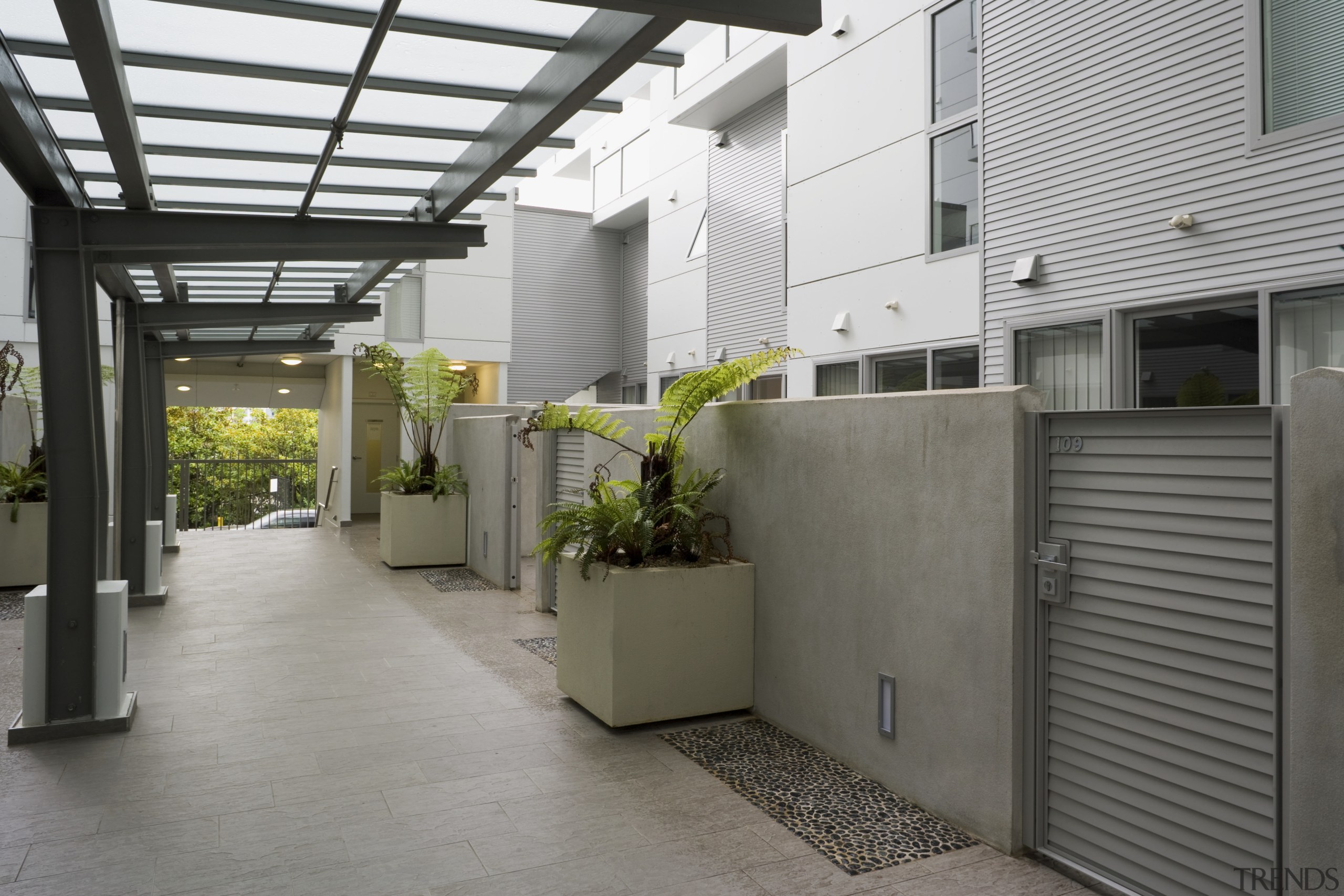 View of a two-storey maisonette which lines the architecture, courtyard, daylighting, house, property, real estate, roof, gray