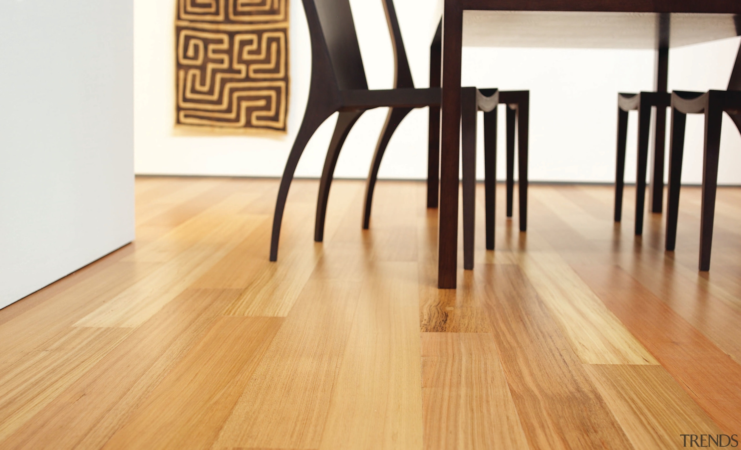 A view of these living areas featuring polished chair, floor, flooring, furniture, hardwood, laminate flooring, product design, table, wood, wood flooring, wood stain, orange, white