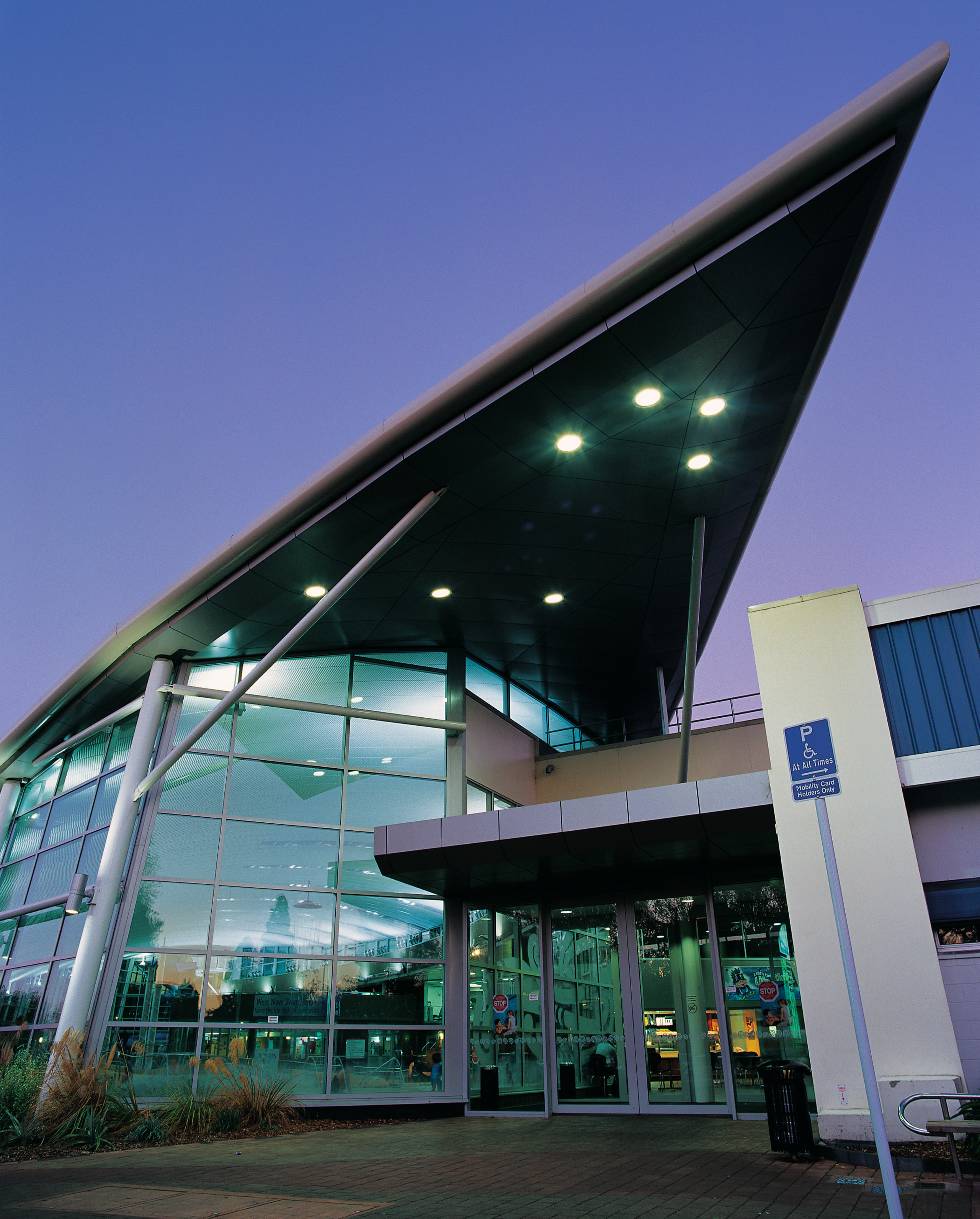 Exterior view of building with extensive glazing and architecture, building, commercial building, corporate headquarters, facade, metropolitan area, mixed use, sky, structure, blue, black