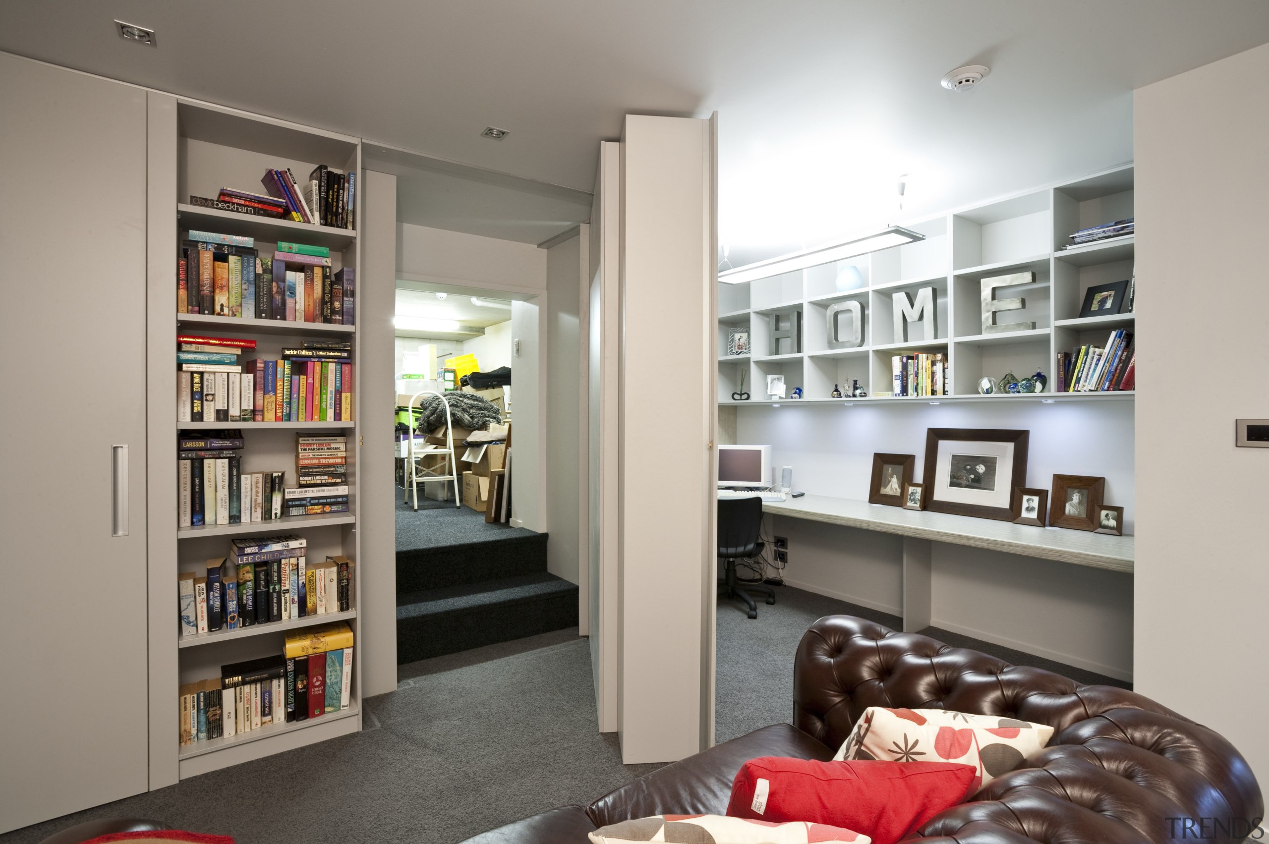 view of a living area in a home bookcase, furniture, interior design, living room, room, shelf, shelving, gray