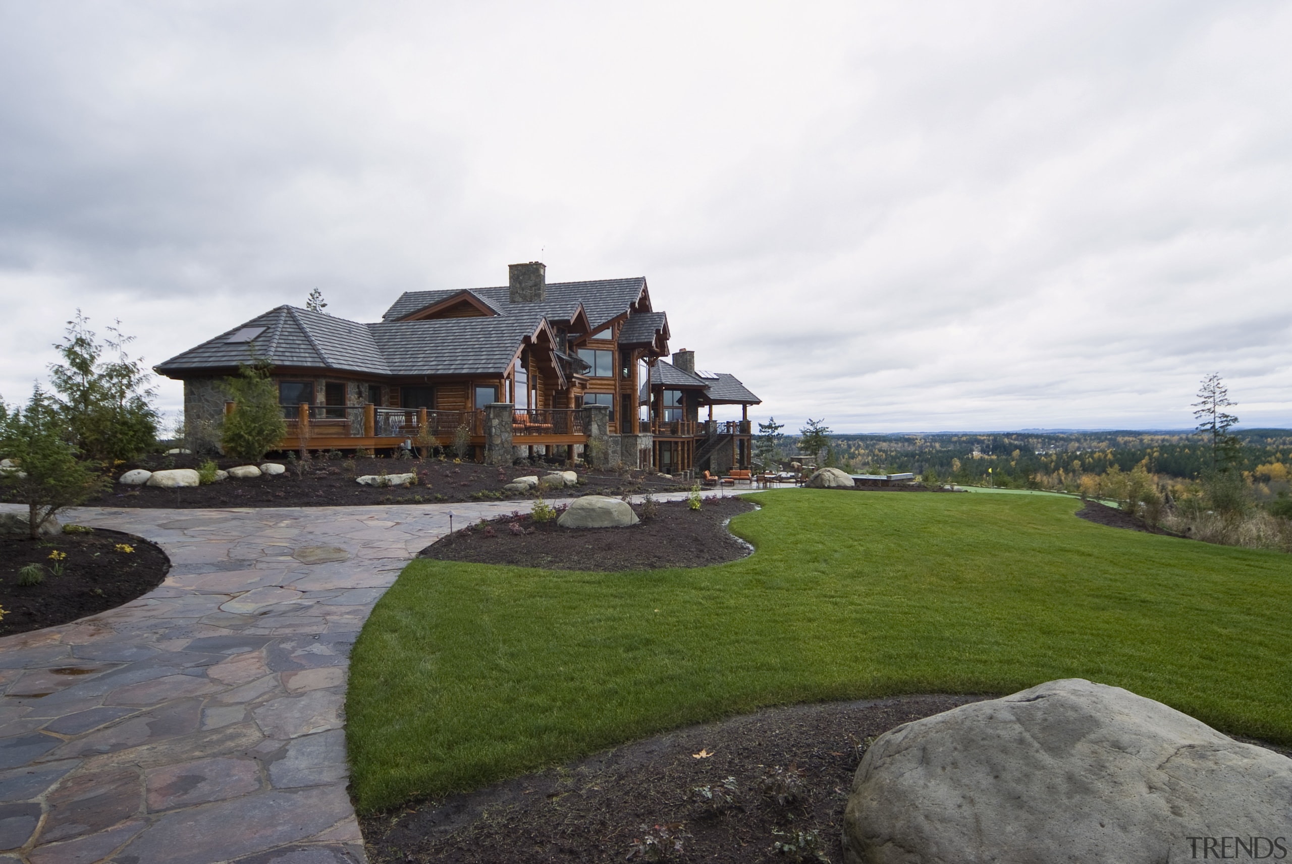 Exterior view of this home which has been backyard, cottage, estate, grass, home, house, land lot, landscape, landscaping, lawn, outdoor structure, property, real estate, yard, white