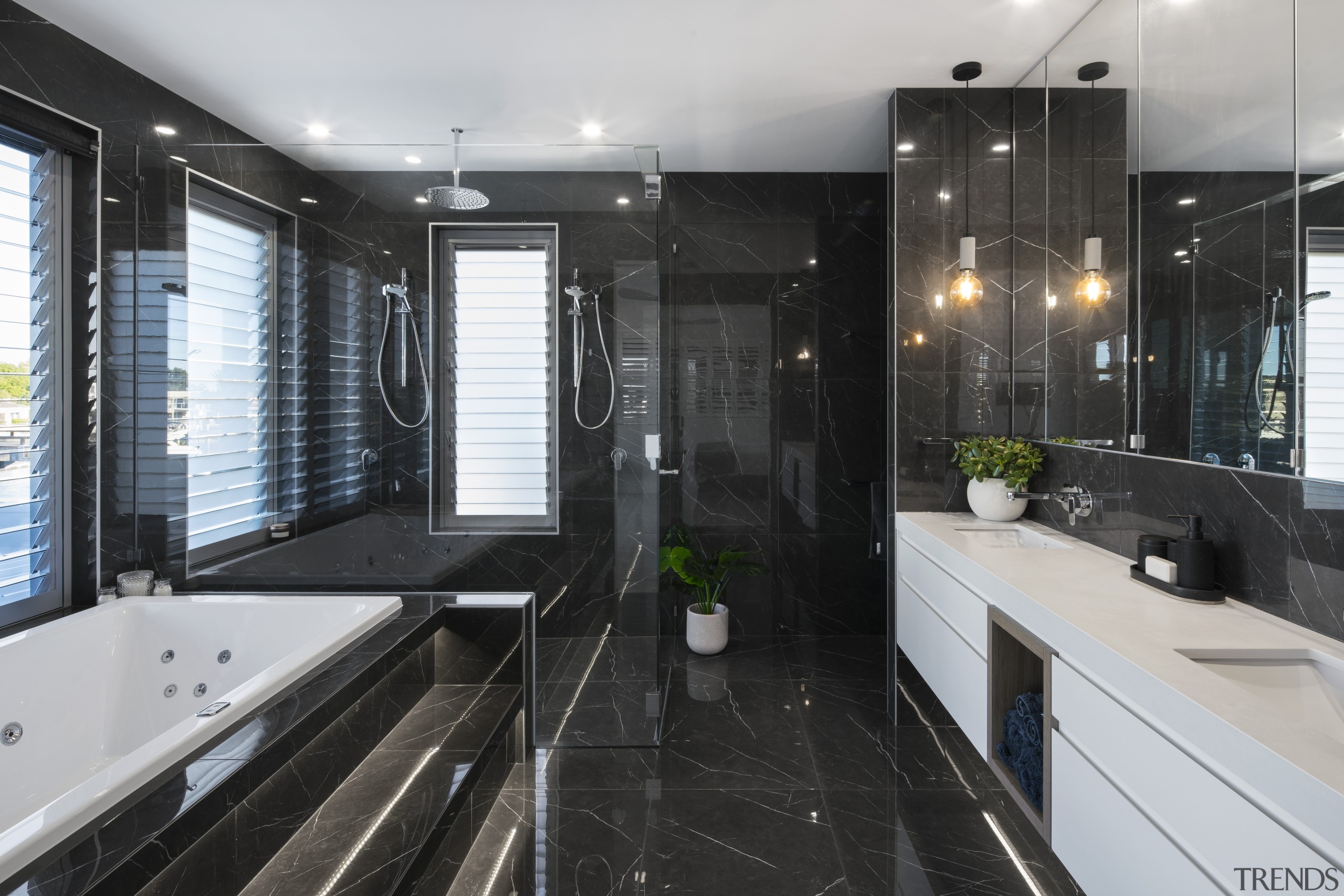 The dark, moody tones of this elegant ensuite apartment, architecture, bathroom, building, cabinetry, ceiling, countertop, floor, flooring, furniture, glass, home, house, interior design, plumbing fixture, property, real estate, room, sink, tile, black, gray