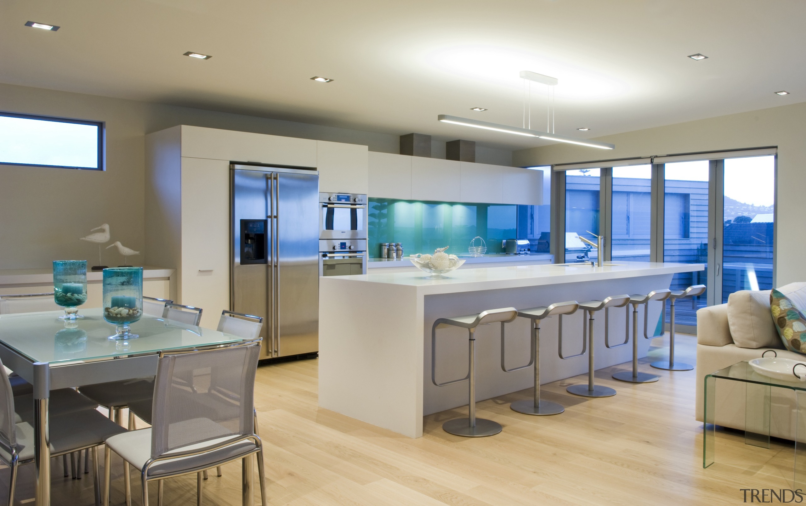 This sleek kitchen in a beach house features countertop, interior design, kitchen, real estate, room, gray