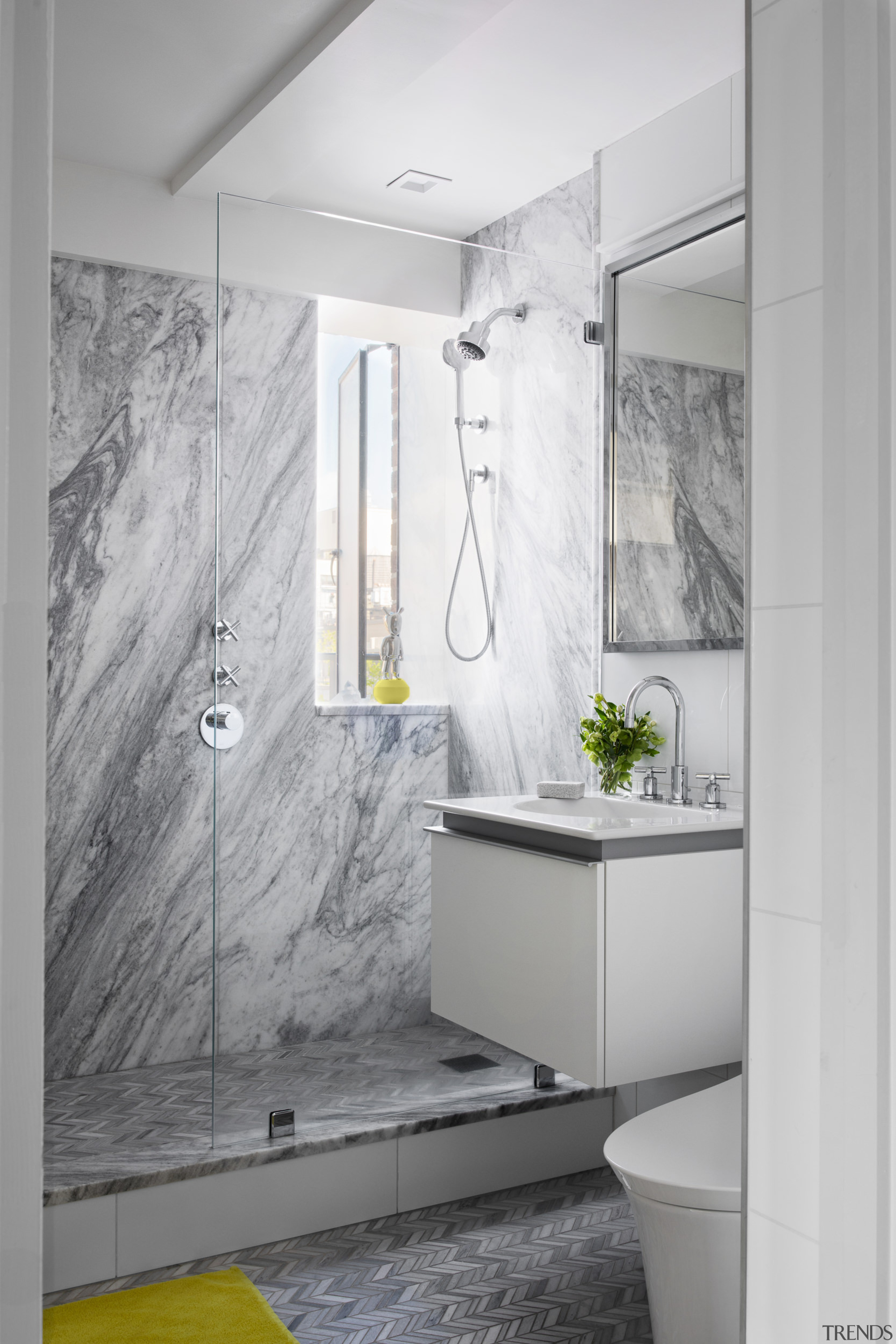 A chevron tile floor features in the bathroom 