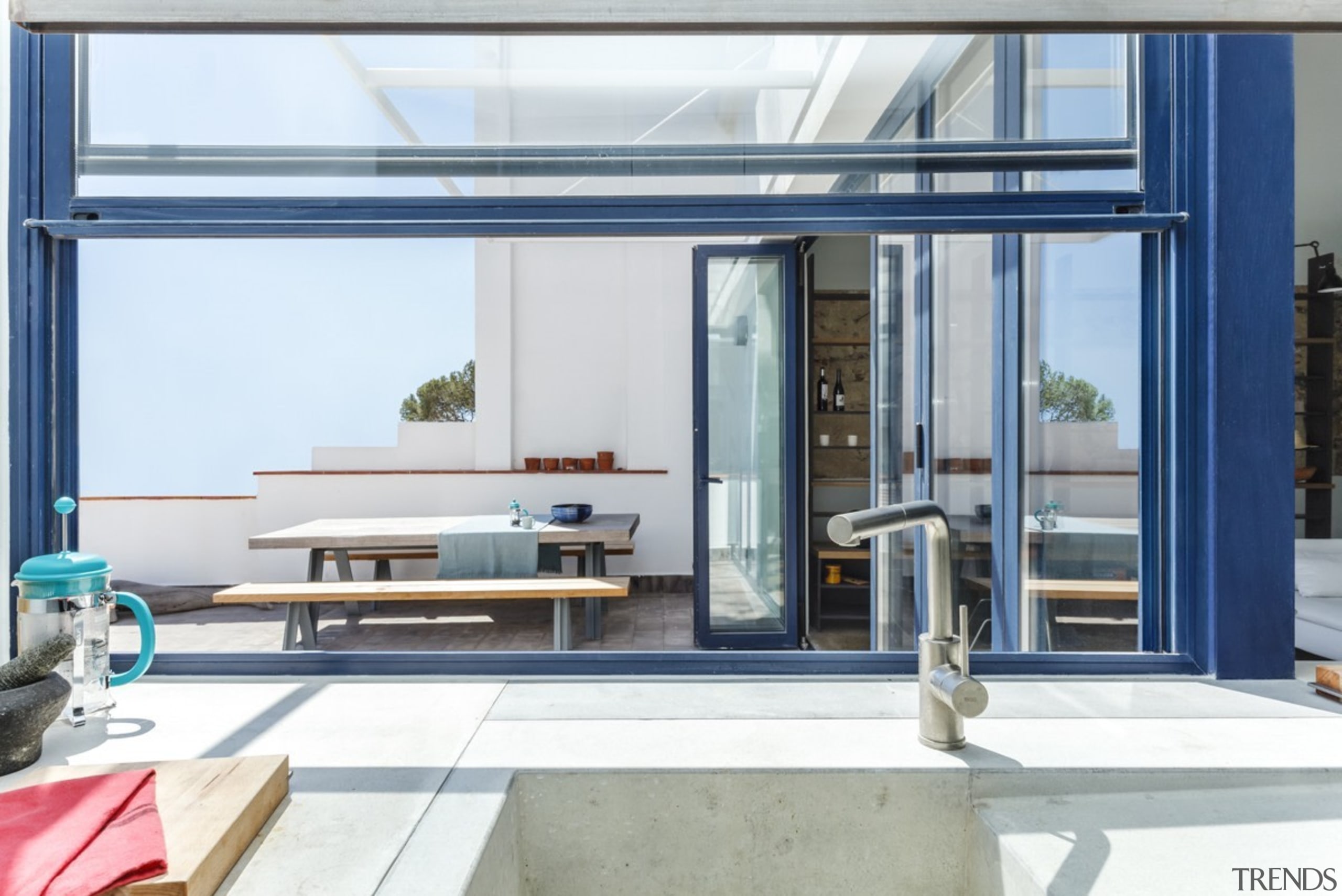 Blue elements carry over from the street - door, interior design, window, white