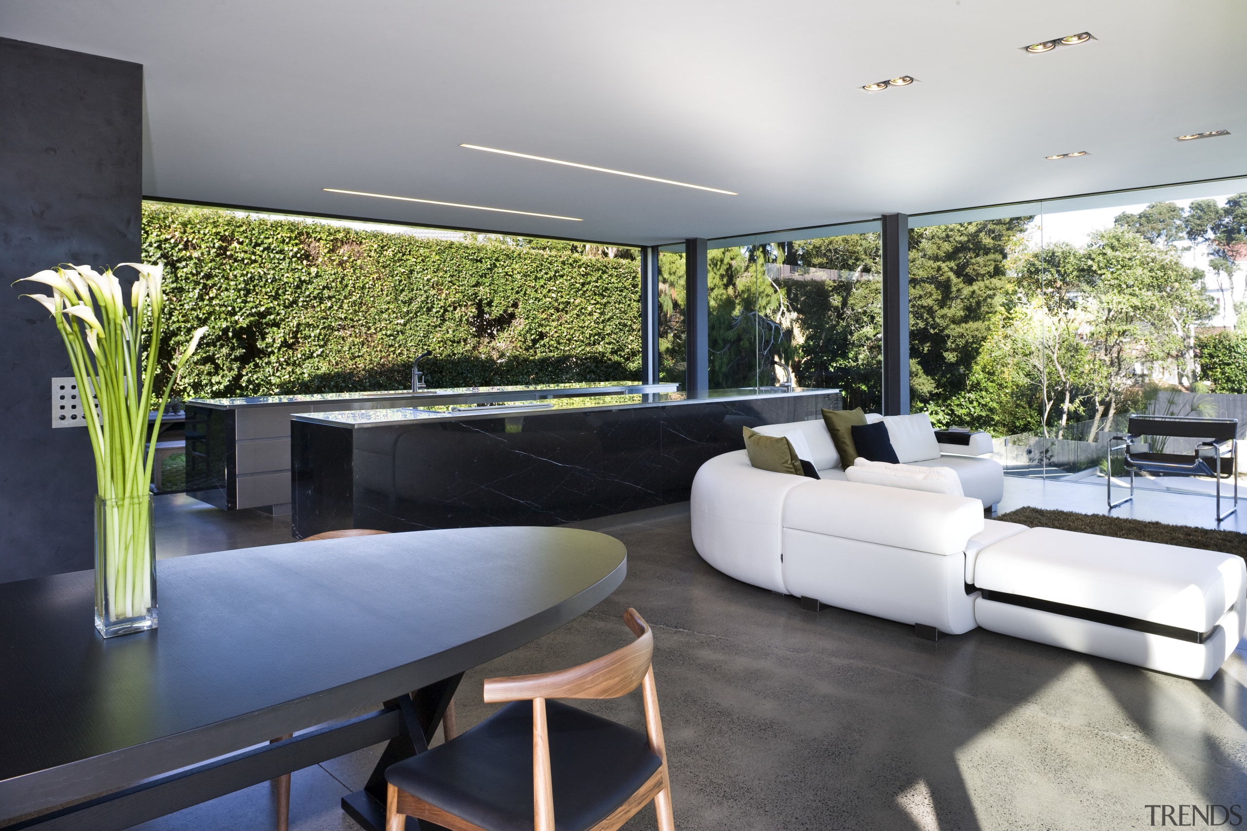View of open-plan kitchen and living area featuring architecture, home, house, interior design, living room, property, real estate, gray, black