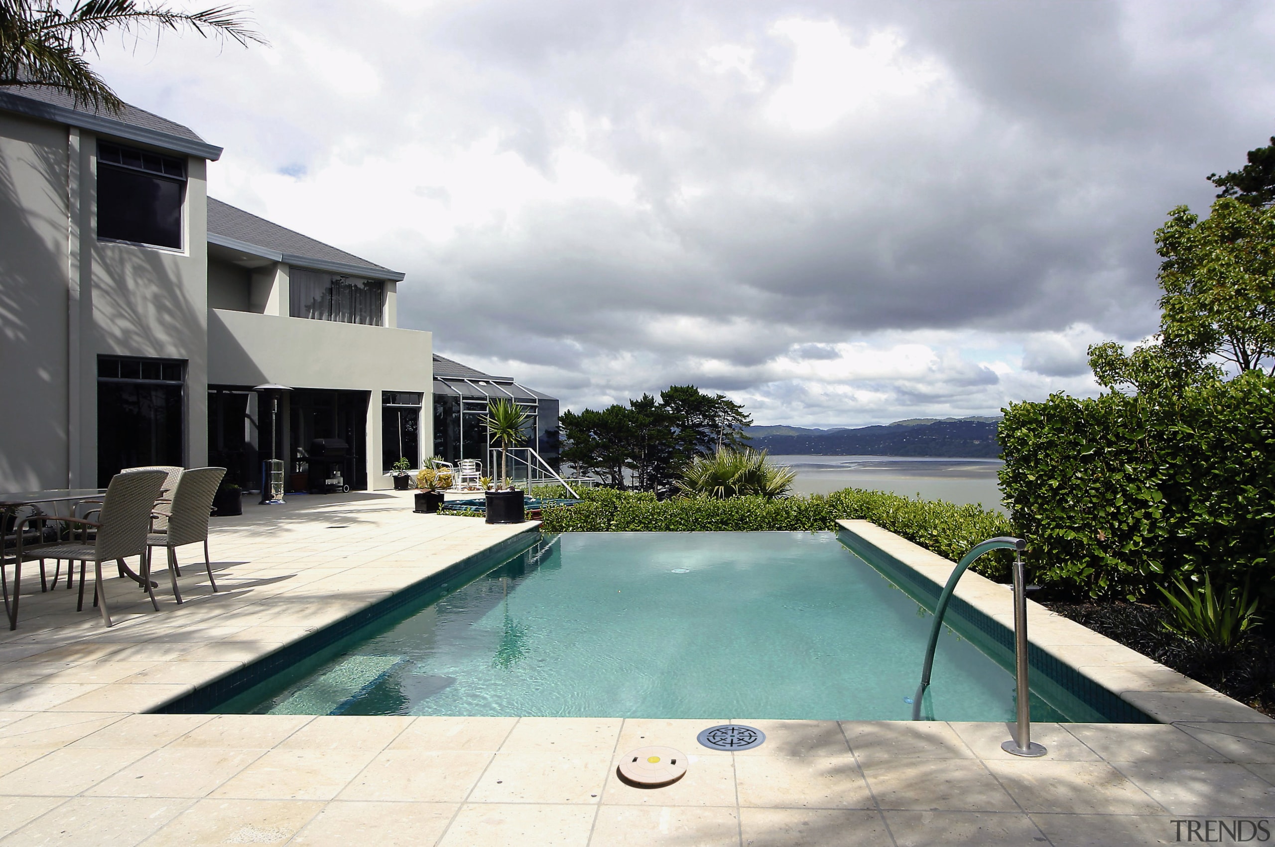 A view of some swimming pool grates. - architecture, estate, home, house, property, real estate, resort, sky, swimming pool, villa, white