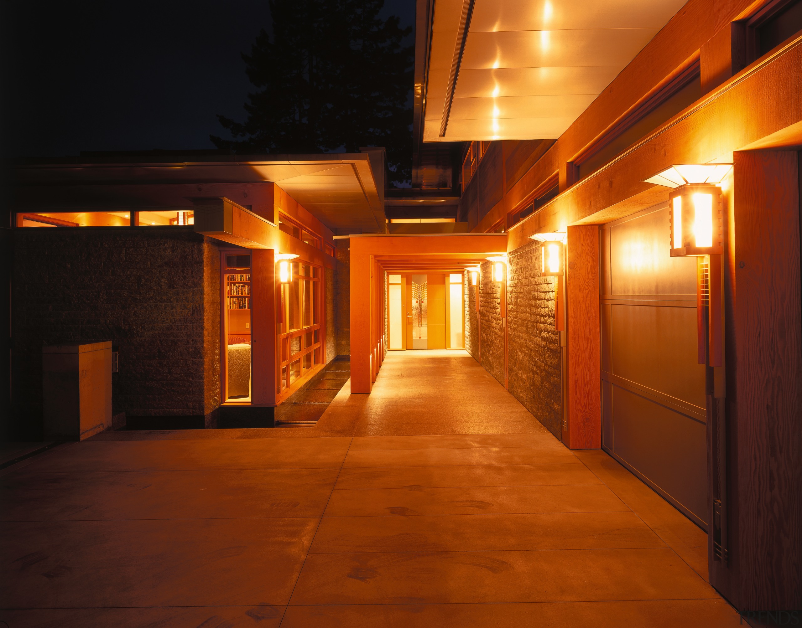 view of the entranceway featuring zinc lined eaves architecture, home, house, light, lighting, night, wood, brown, black