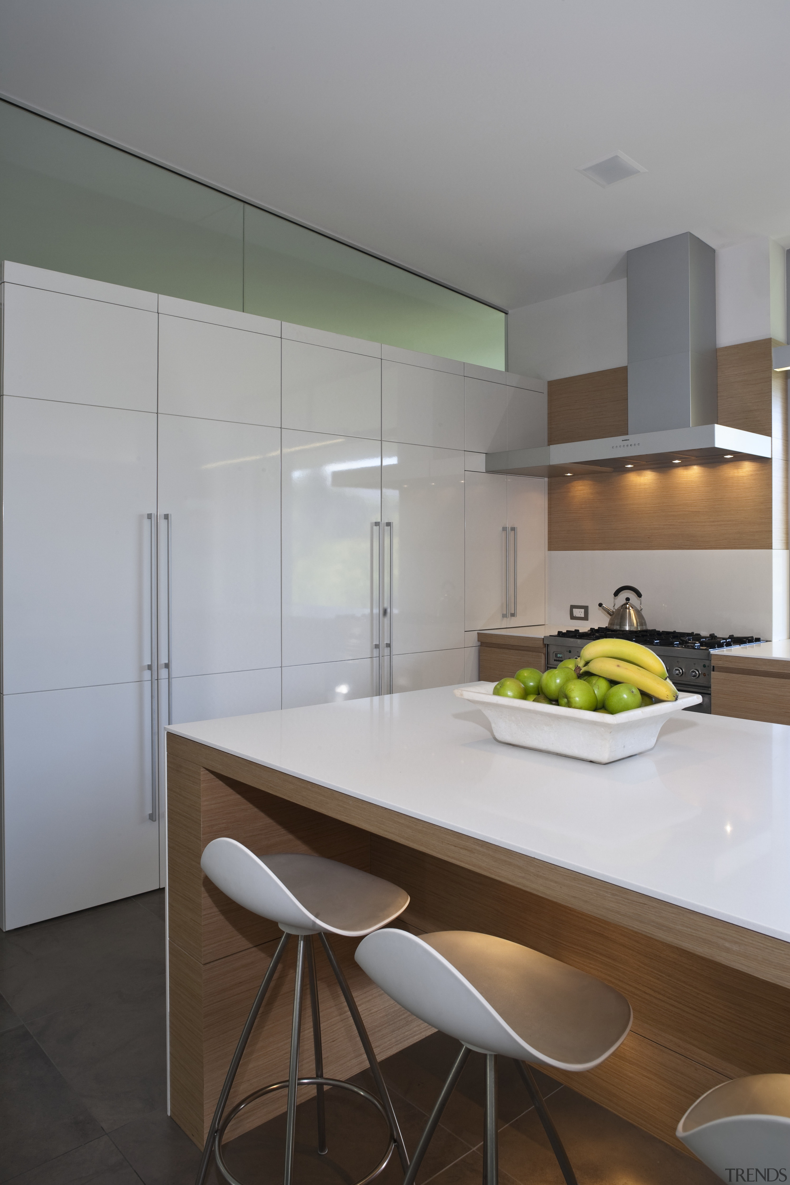 View of kitchen and living area featuring light architecture, countertop, floor, house, interior design, kitchen, product design, real estate, room, table, gray