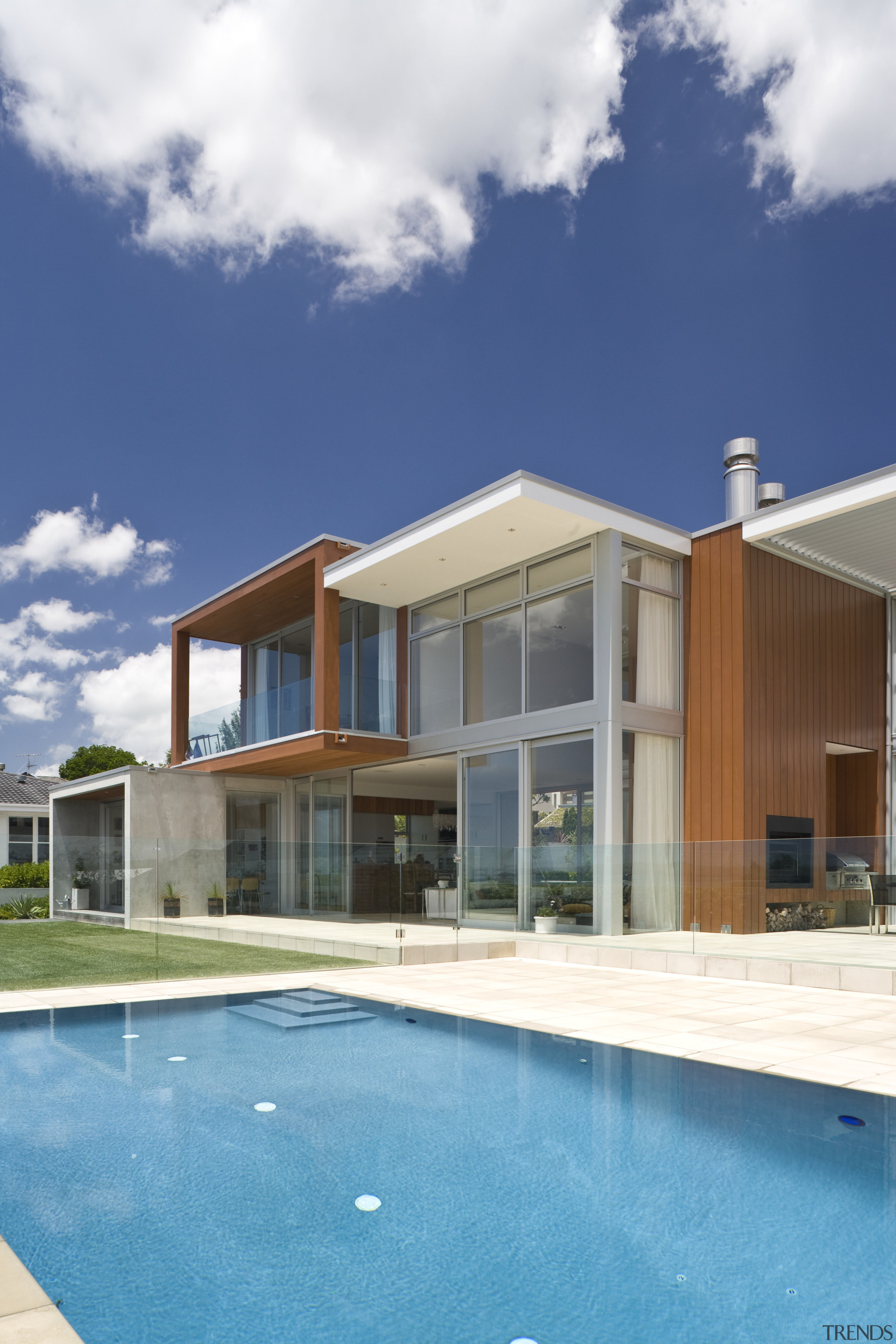 Exterior view of home and pool with framelss architecture, elevation, estate, facade, home, house, property, real estate, residential area, sky, swimming pool, villa, window, white