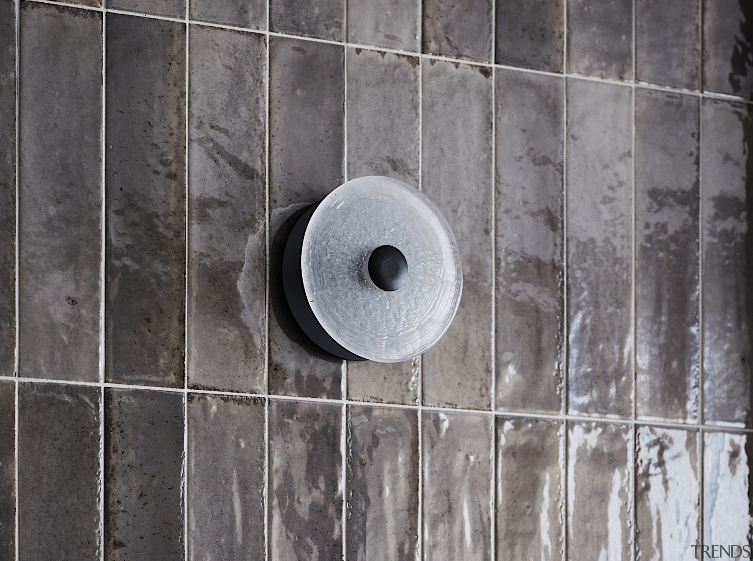 Handmade, glazed vertical subway tiles create a glistening 