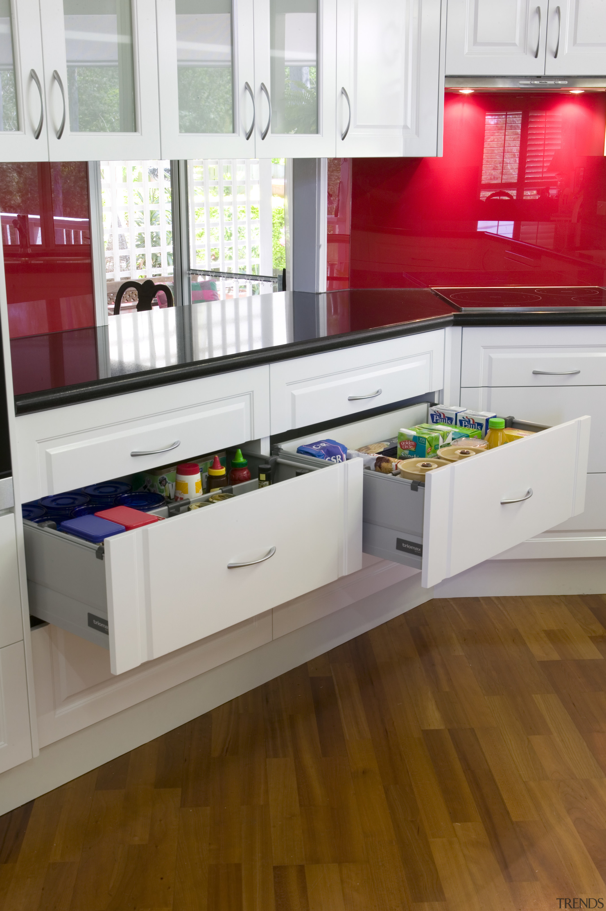 A view of a drawer system by Harn. countertop, floor, flooring, hardwood, interior design, kitchen, laminate flooring, product, product design, room, wood flooring, white, brown