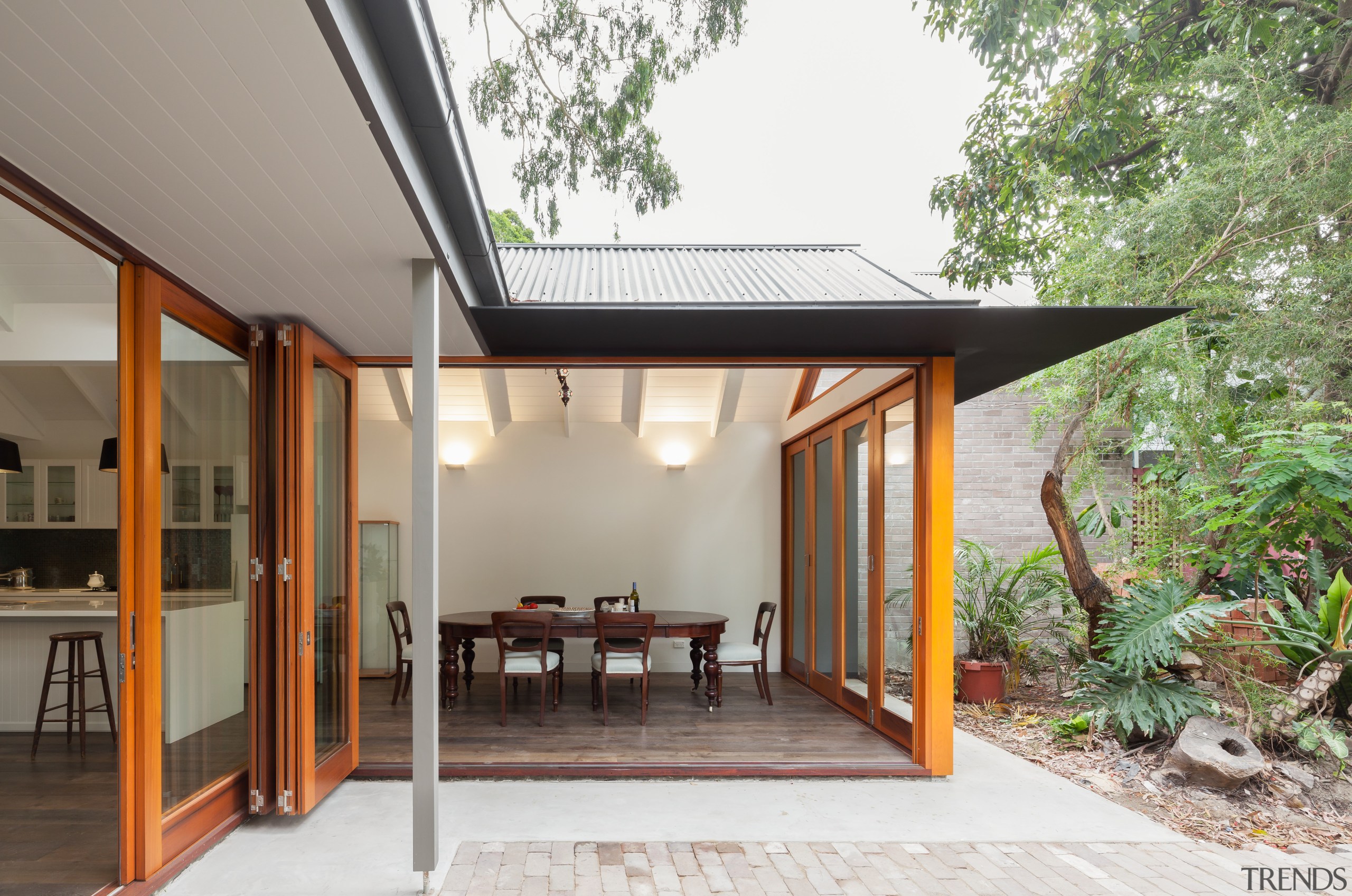 The thin-edged steel awning around this open-plan dining architecture, courtyard, home, house, property, real estate, roof, gray