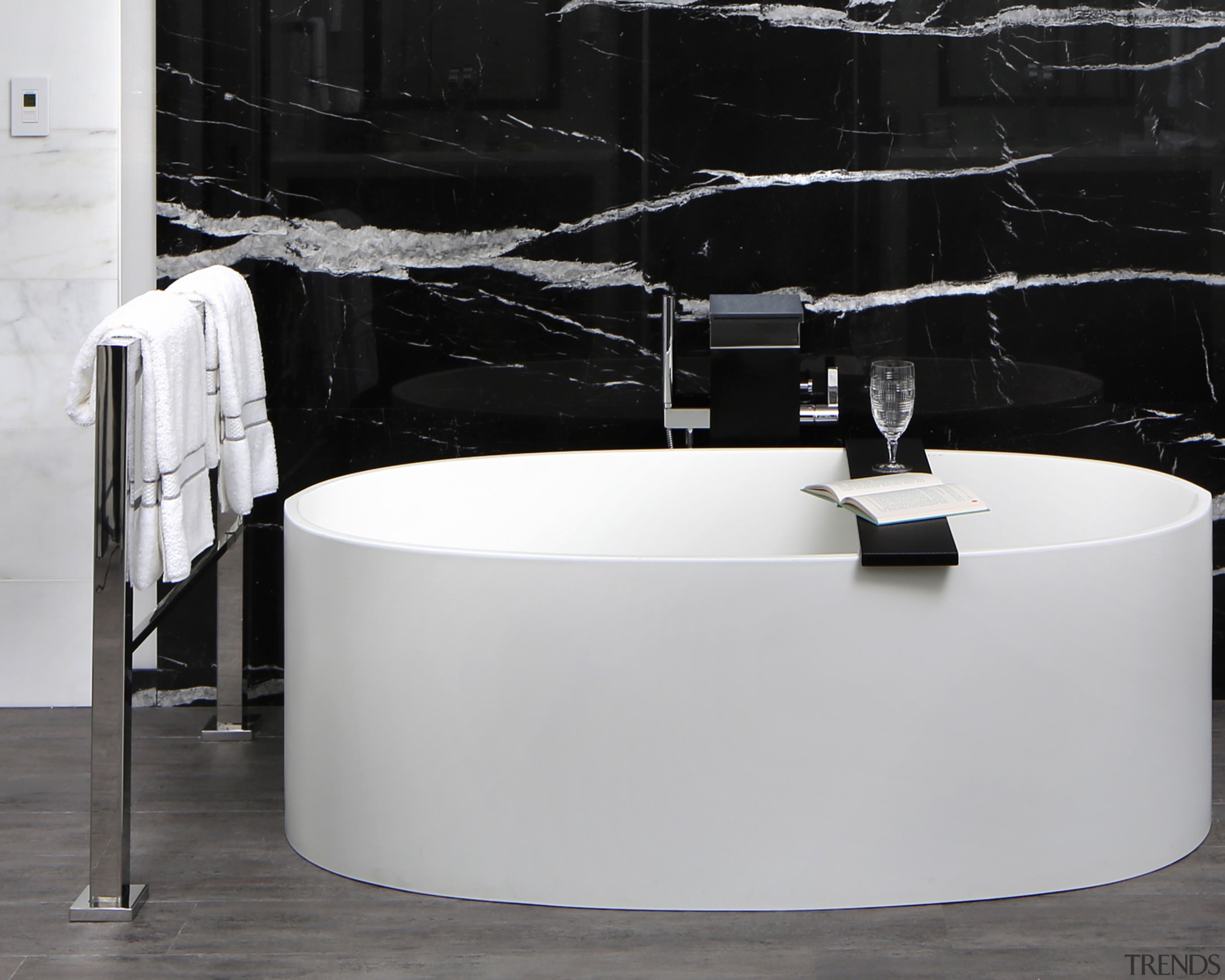 This floor-mounted towel warmer is readily accessible from angle, bathroom, bathroom sink, floor, furniture, interior design, plumbing fixture, product design, sink, table, tap, gray, black