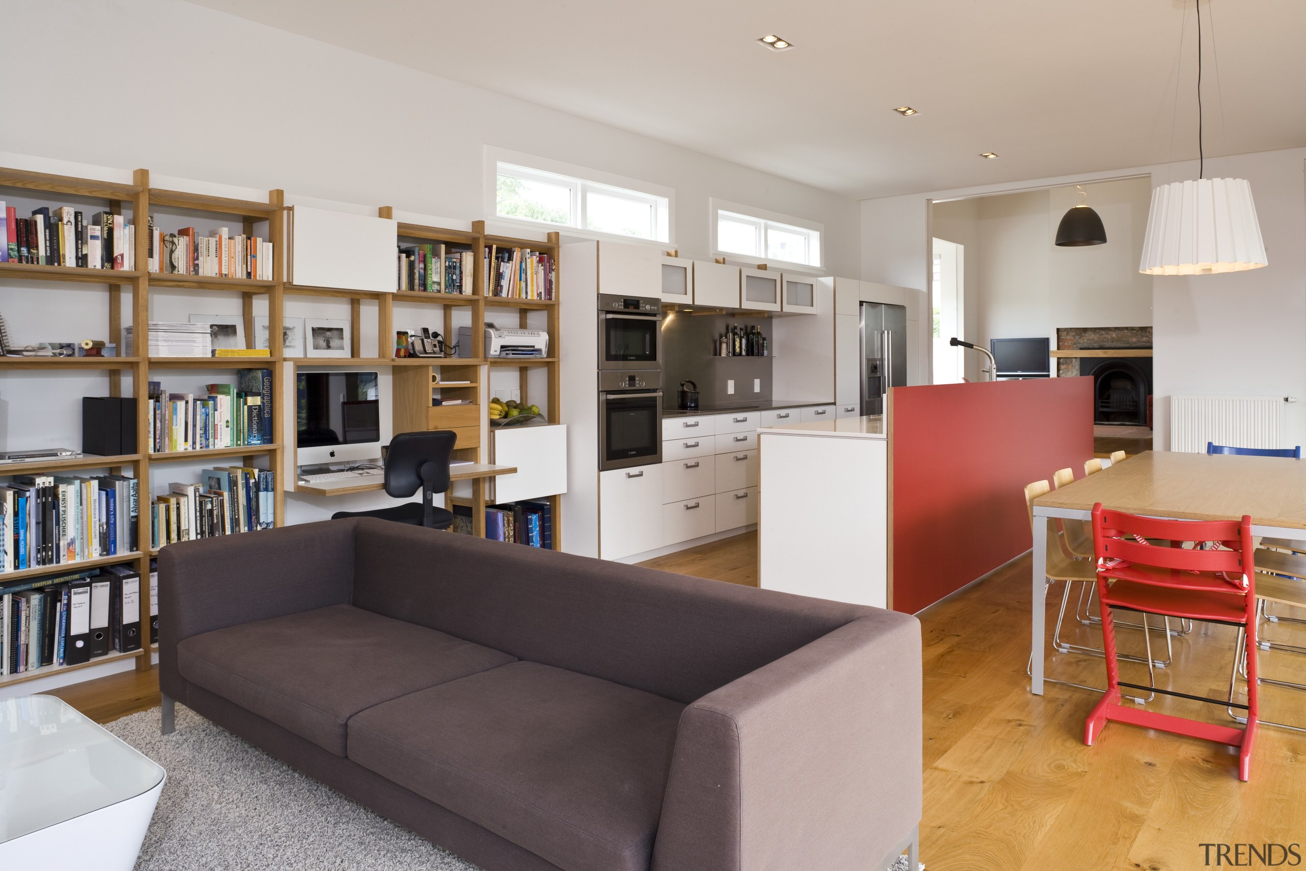View of open-plan kitchen area which features an bookcase, furniture, institution, interior design, library, living room, real estate, room, shelving, gray