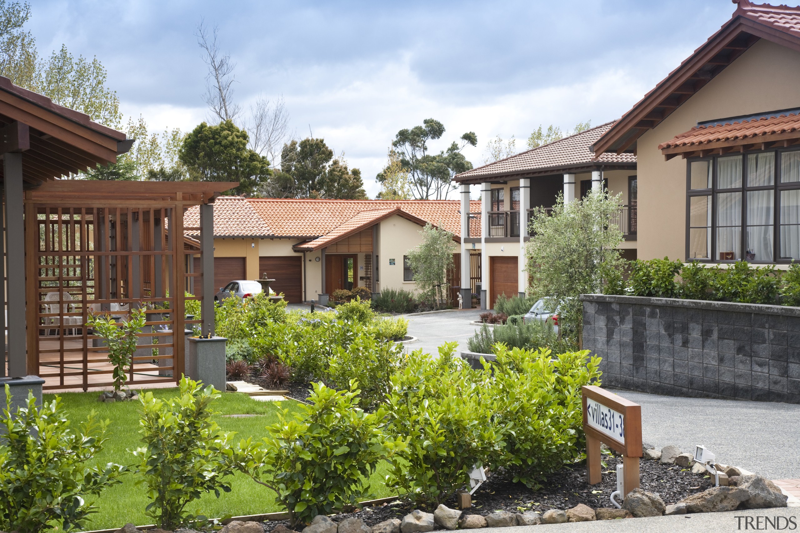 View of the St Andrews Village. - View backyard, cottage, courtyard, estate, facade, fence, garden, home, house, land lot, landscaping, neighbourhood, outdoor structure, plant, property, real estate, residential area, villa, yard, white, brown