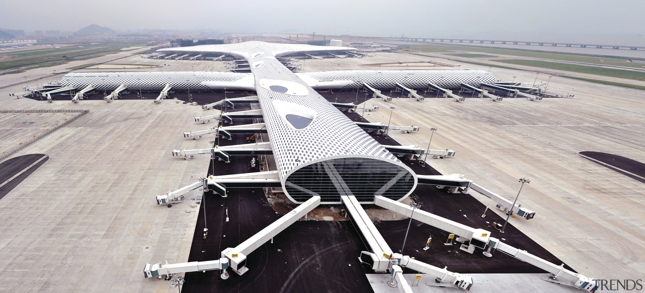 Looking much like a giant sculpture from both aerospace engineering, air travel, aircraft, airline, airplane, airport, airport apron, airport terminal, aviation, bird's eye view, flap, runway, wing, gray