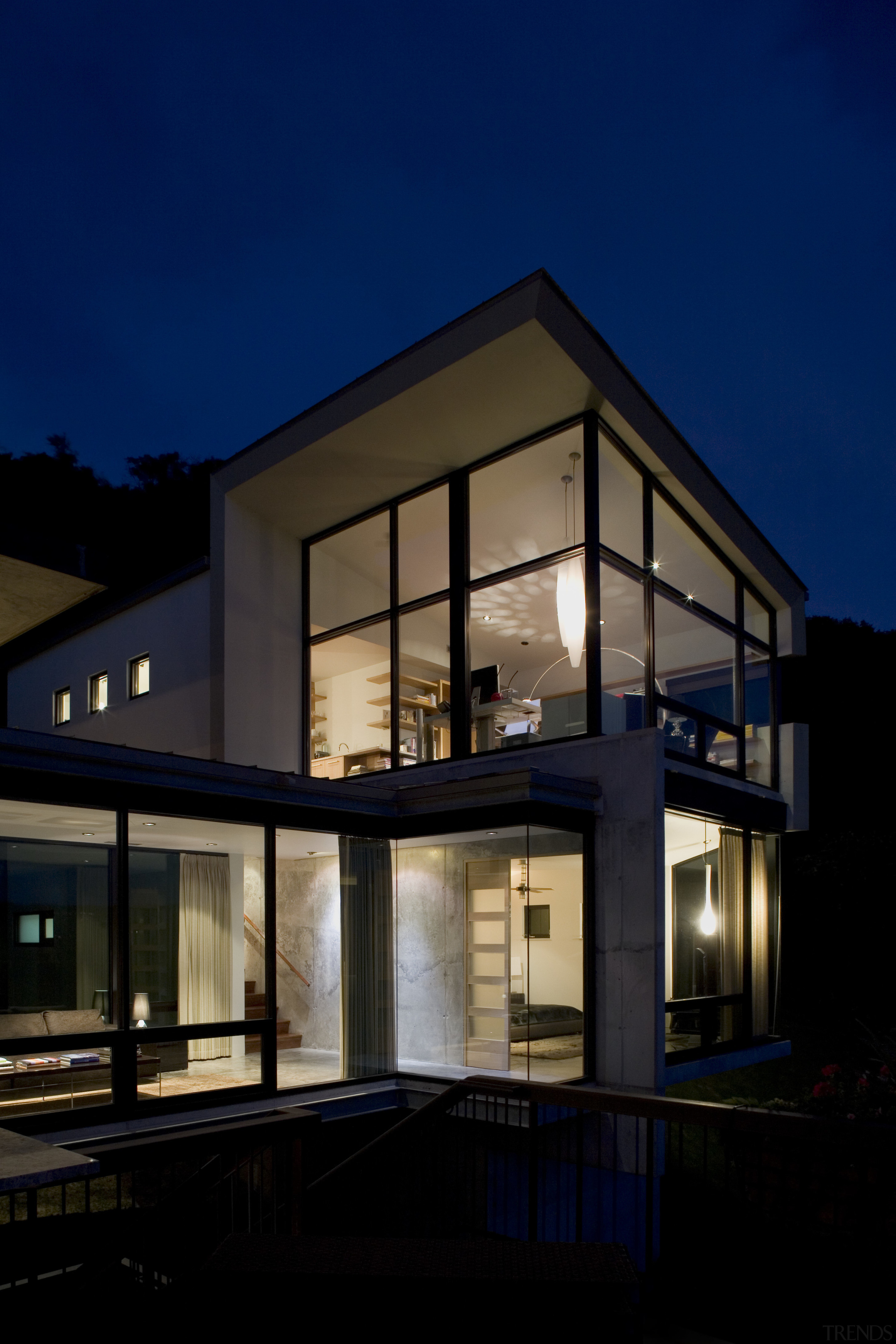 Evening view of the exterior of this bedroom architecture, building, facade, home, house, lighting, property, real estate, reflection, residential area, sky, window, black, blue