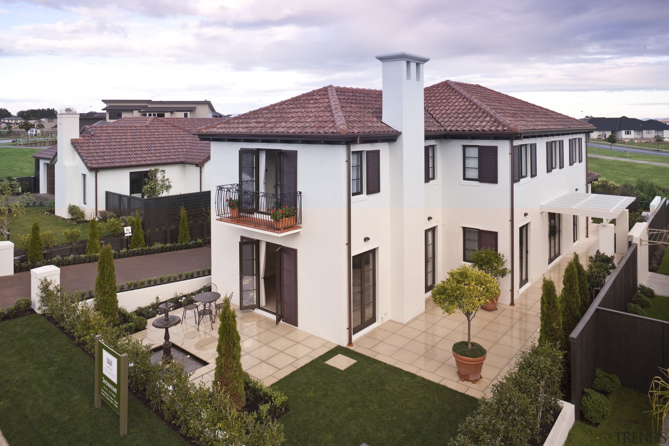 Exterior view of Eden Homes show home which cottage, elevation, estate, facade, home, house, mansion, neighbourhood, property, real estate, residential area, roof, suburb, villa, white, brown