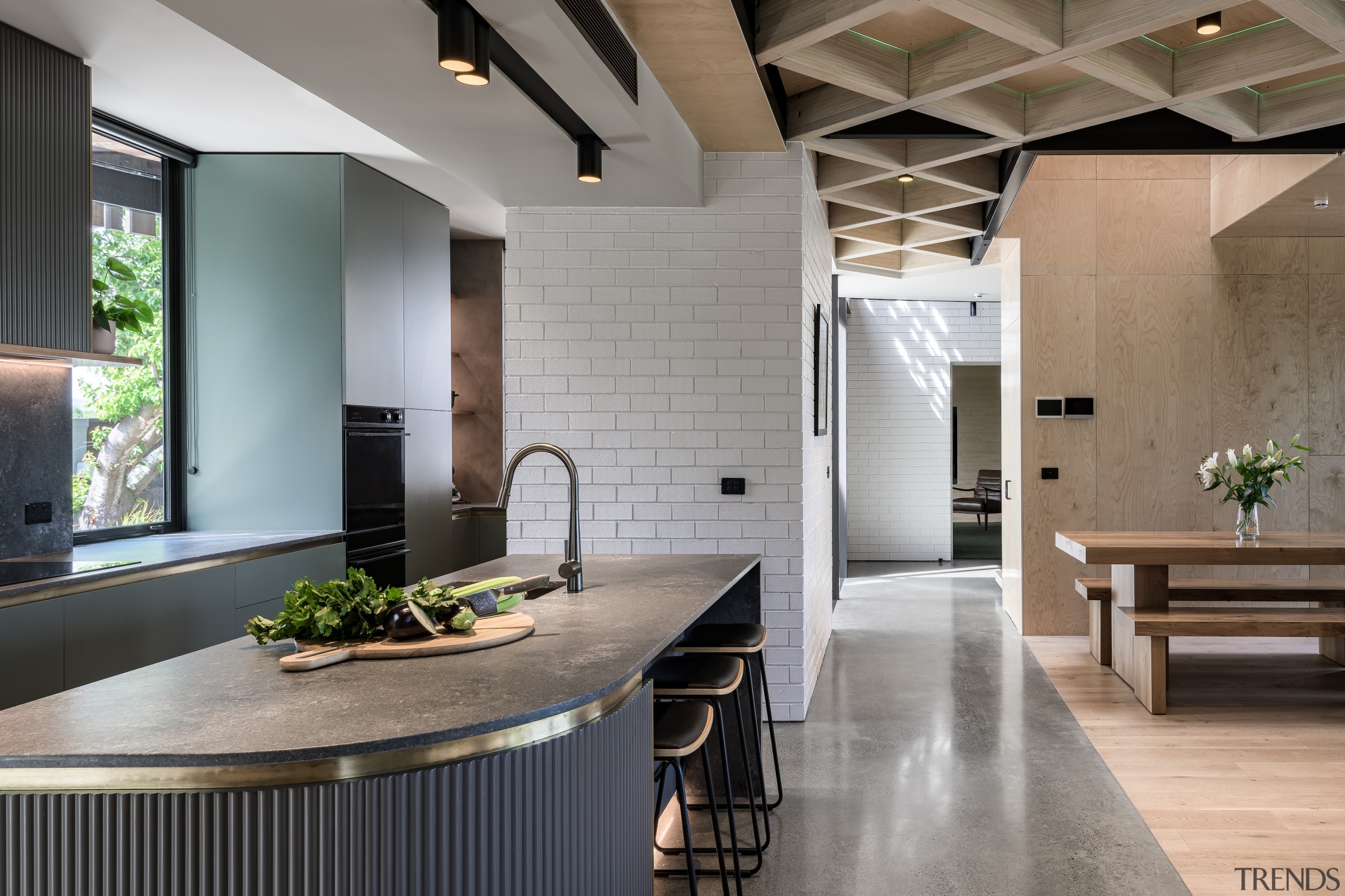 Brushed brass detailing subtly enhances the kitchen's rich 