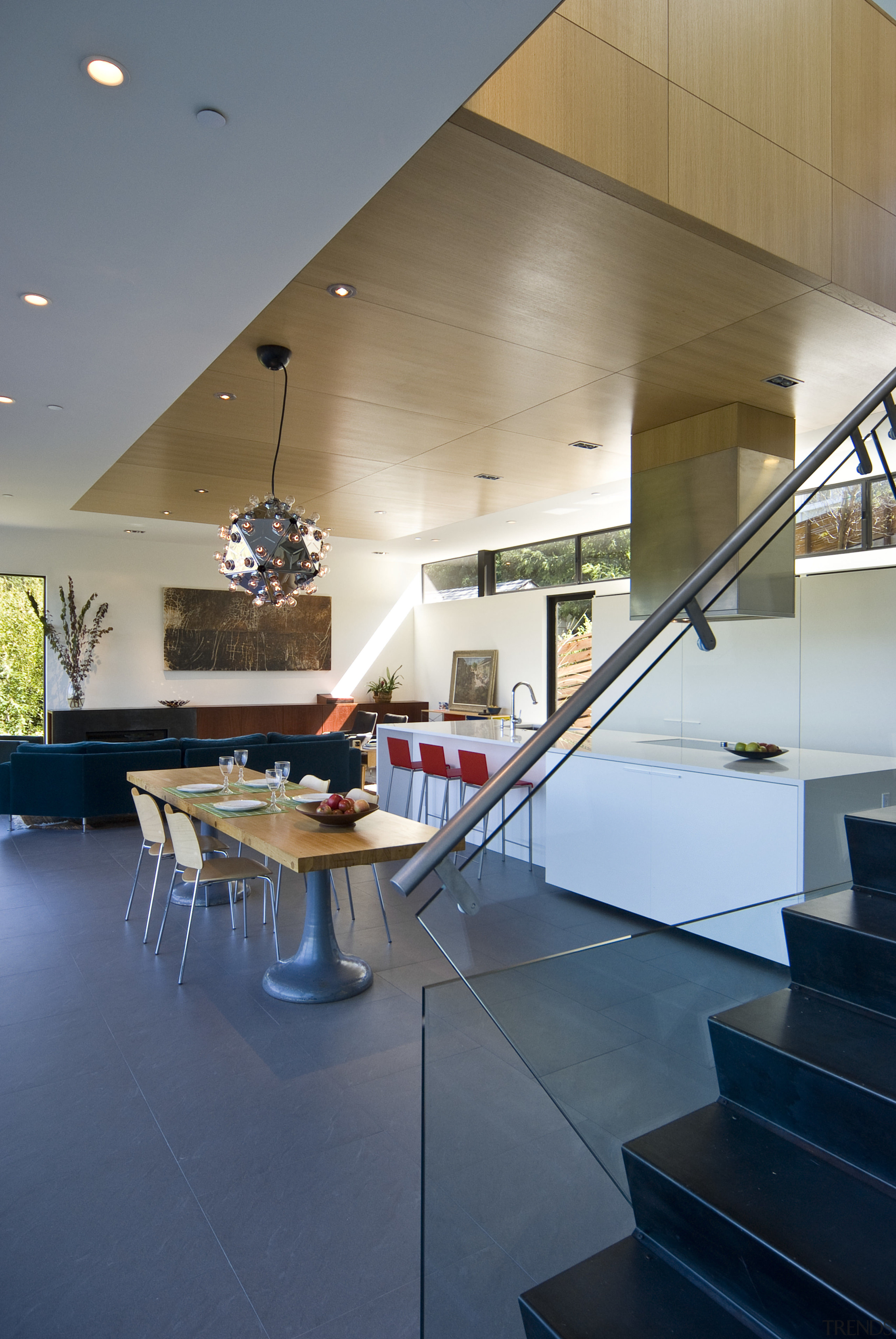 View of kitchen designed by Tim Rempel of apartment, architecture, ceiling, daylighting, floor, flooring, glass, handrail, home, house, interior design, lobby, loft, real estate, stairs, table