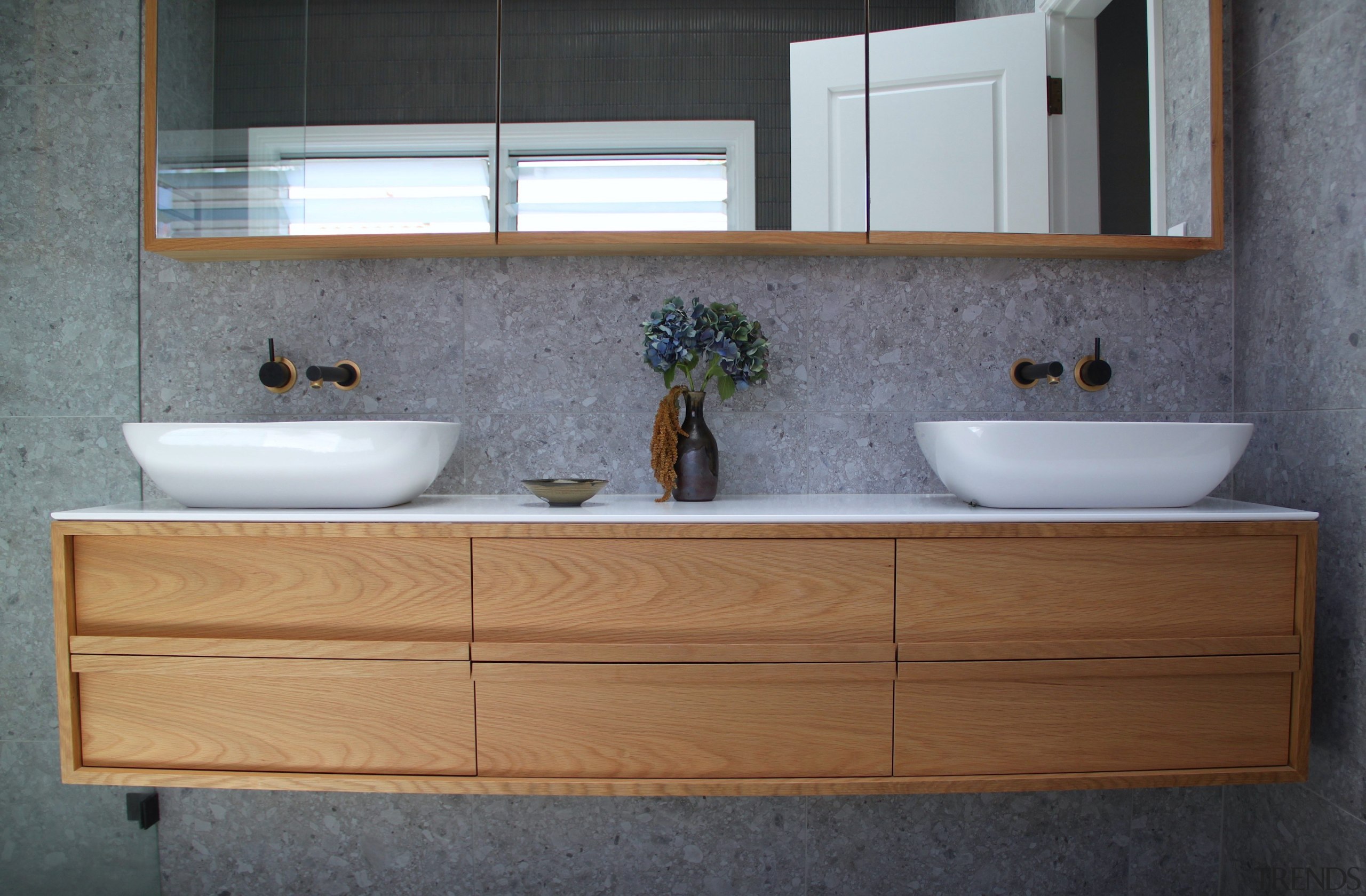 For the ensuite, pairing natural timber vanity and 