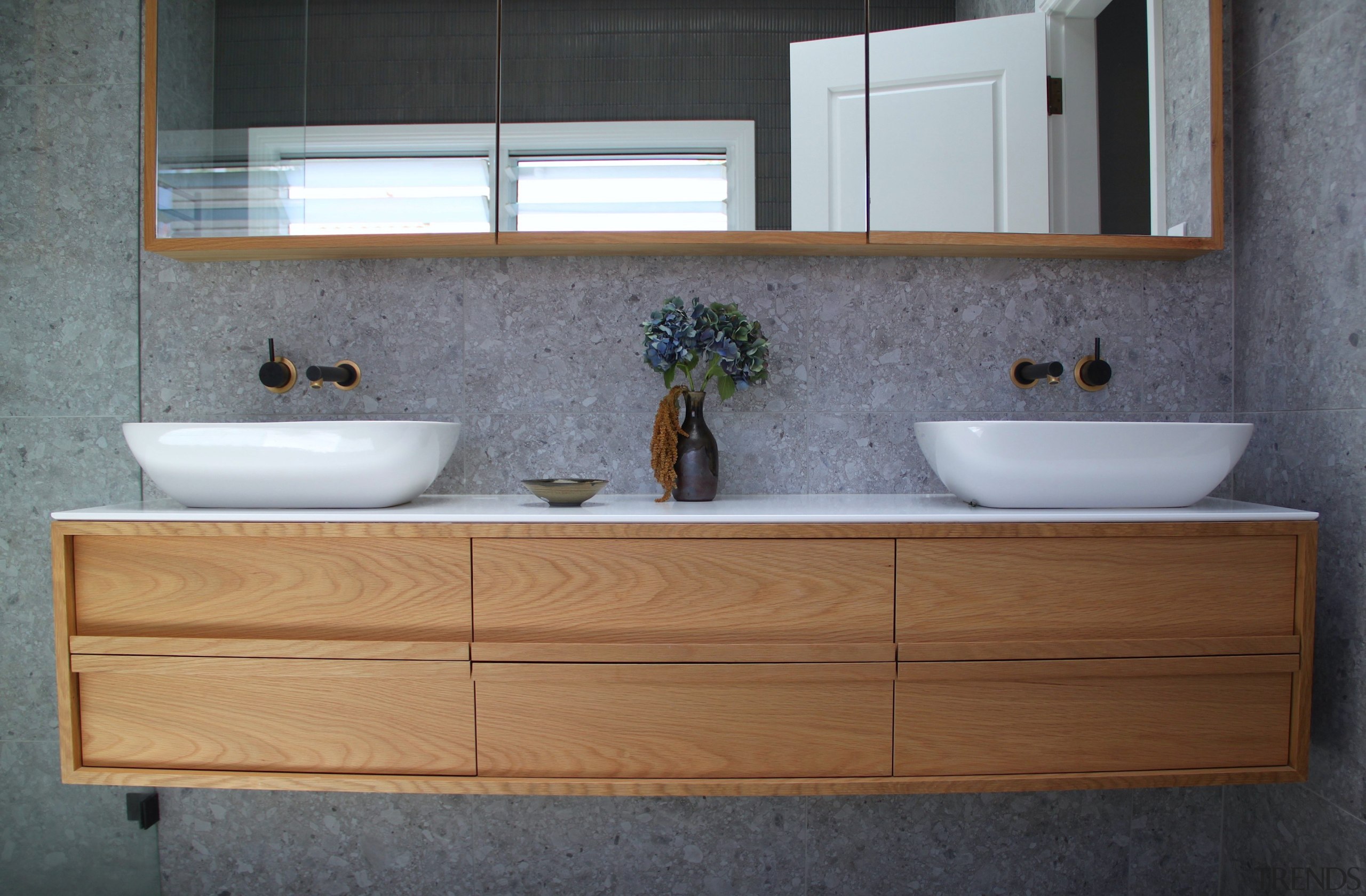 For the ensuite, pairing natural timber vanity and 