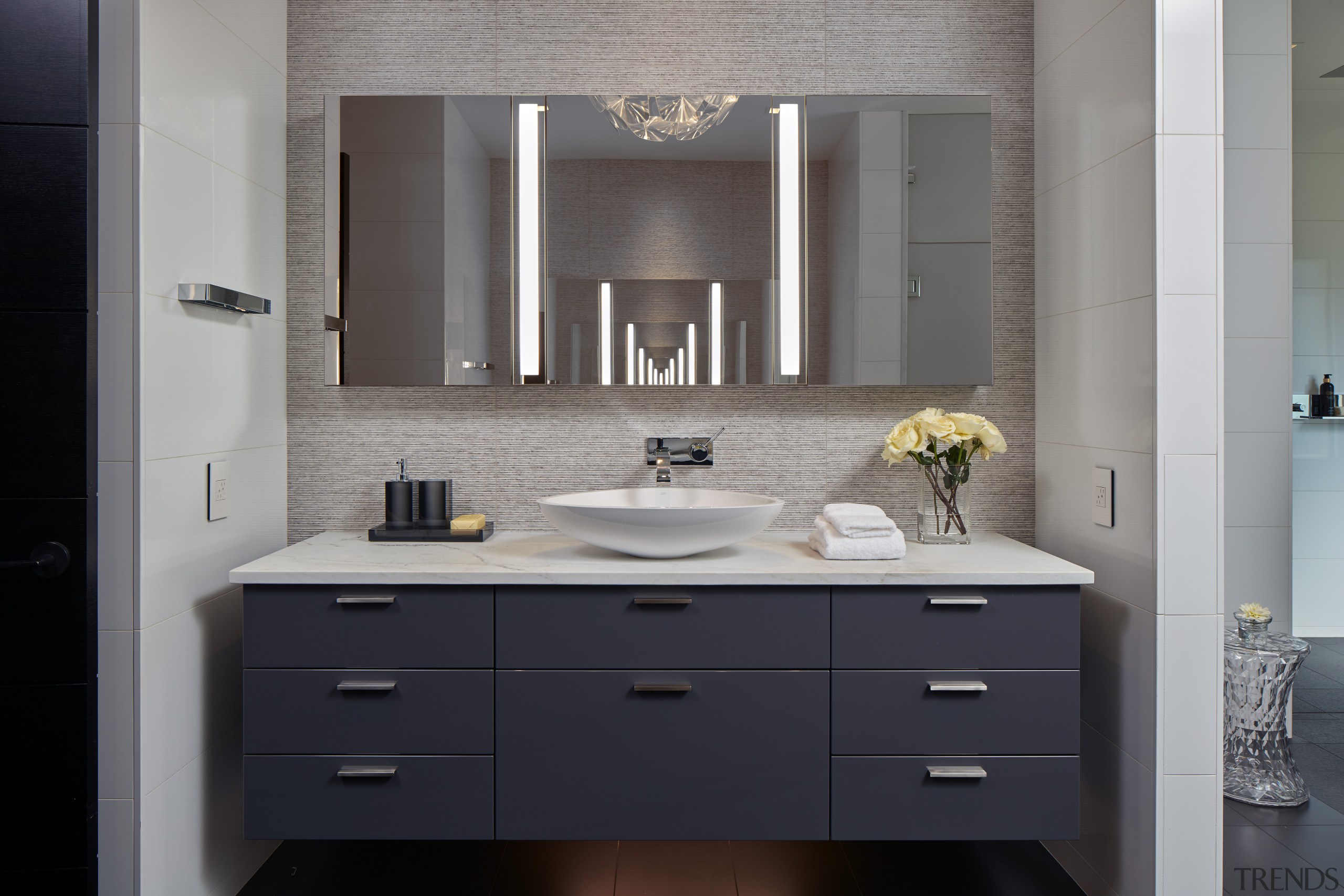 ​​​​​​​Set directly opposite each other, the wall-hung, mirror-fronted bathroom, bathroom accessory, bathroom cabinet, cabinetry, countertop, floor, interior design, kitchen, room, sink, gray, black