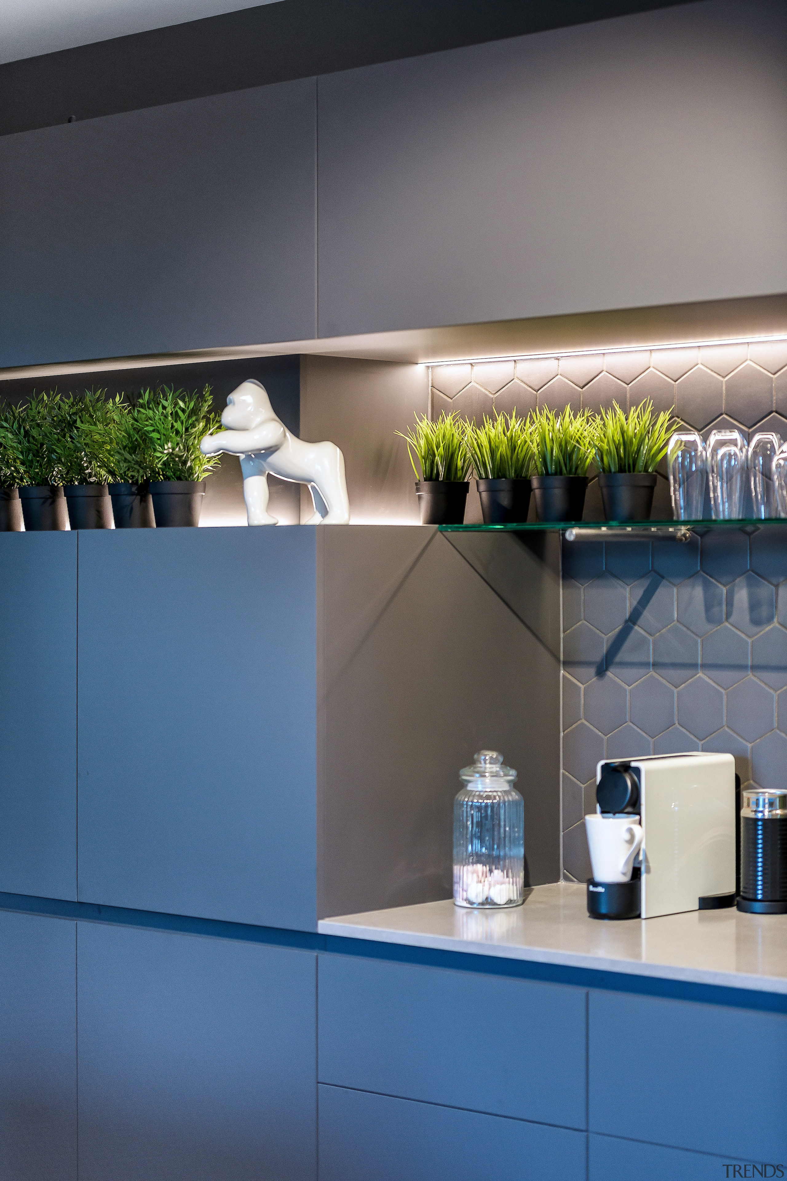 Kitchen joinery is sleek with continuous horizontal recesses 