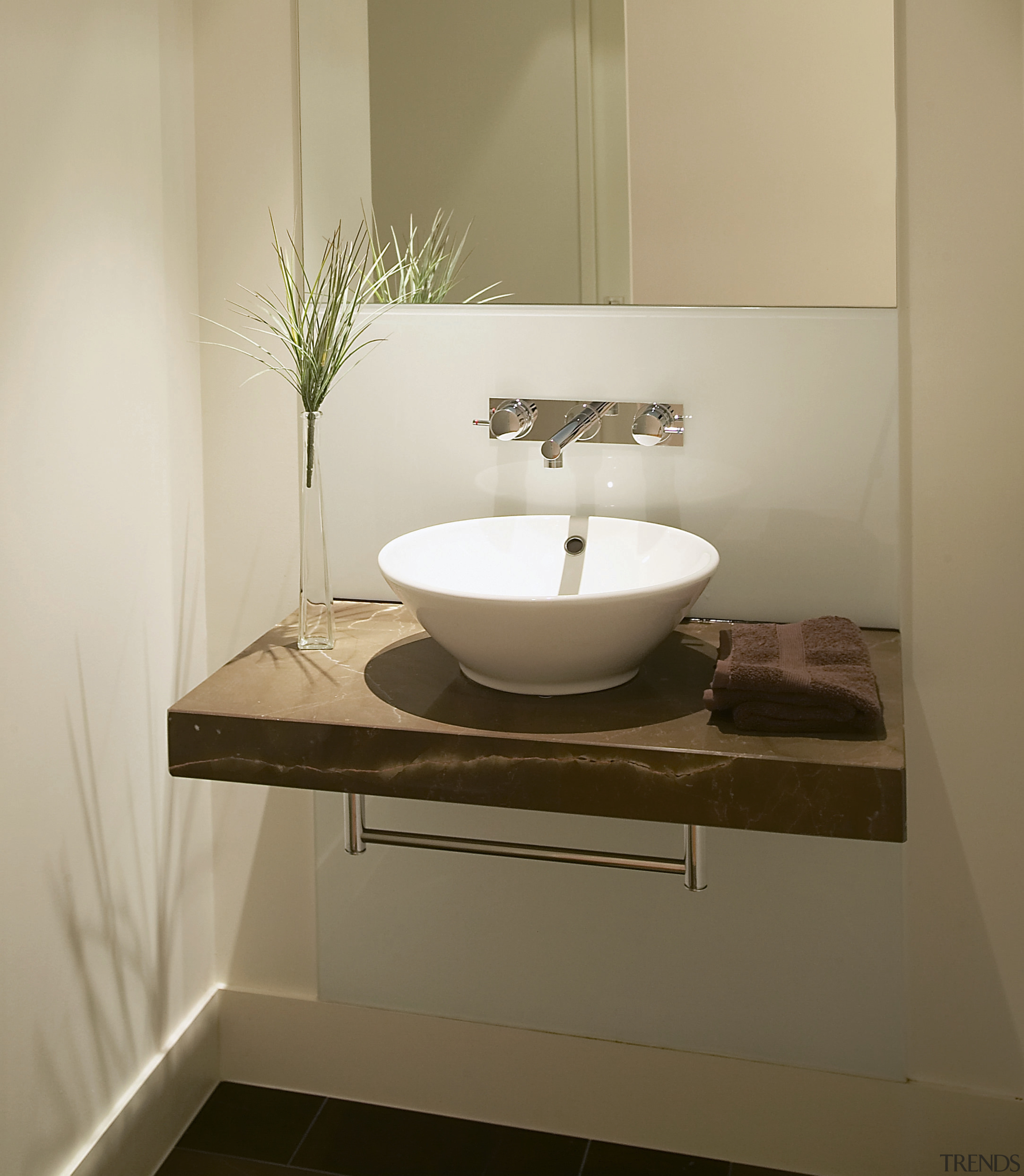 A view of a Far East Consortium apartment bathroom, bathroom accessory, bathroom cabinet, bathroom sink, ceramic, countertop, floor, interior design, plumbing fixture, product design, room, shelf, sink, tap, tile, brown, gray