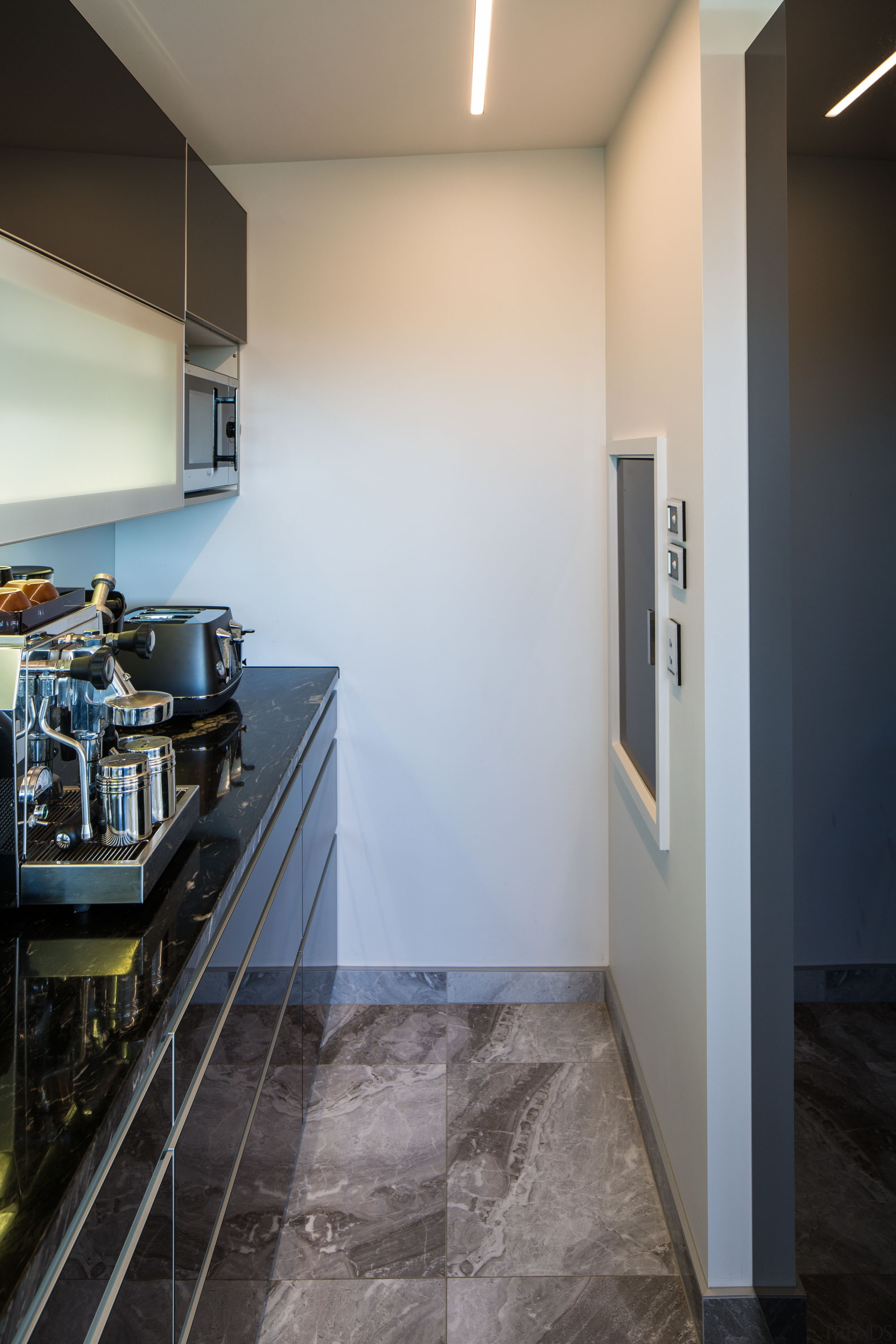 A recess area at the rear of the architecture, ceiling, countertop, daylighting, floor, flooring, home, house, interior design, real estate, room, tile, wall, gray, black