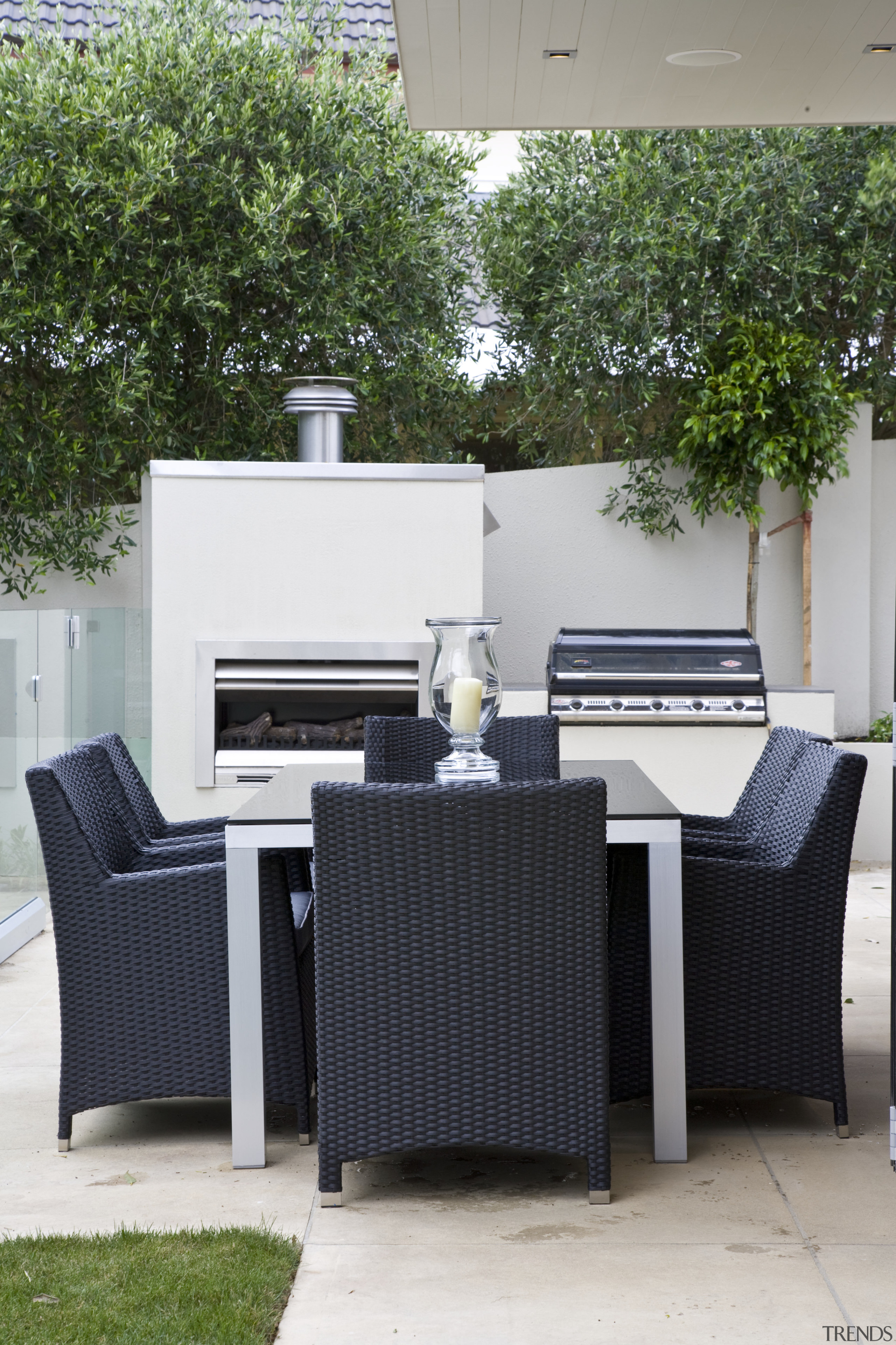 Image of the exterior of this home. Outdoor chair, furniture, outdoor structure, patio, table, wicker, white