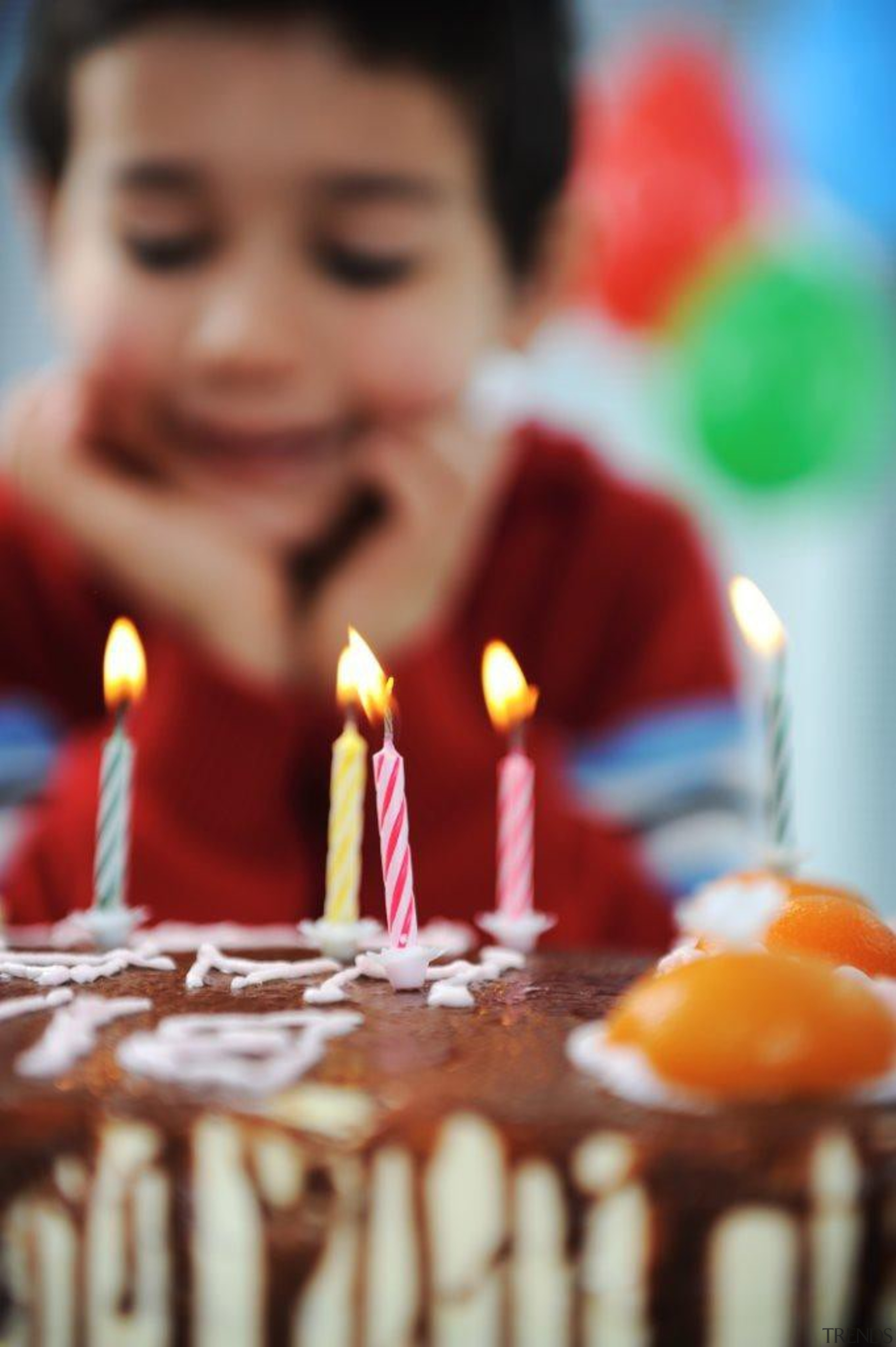 A little boy about to blow out his baked goods, baking, birthday, birthday cake, cake, cake decorating, chocolate cake, dessert, flavor, food, icing, sweetness, torte, red