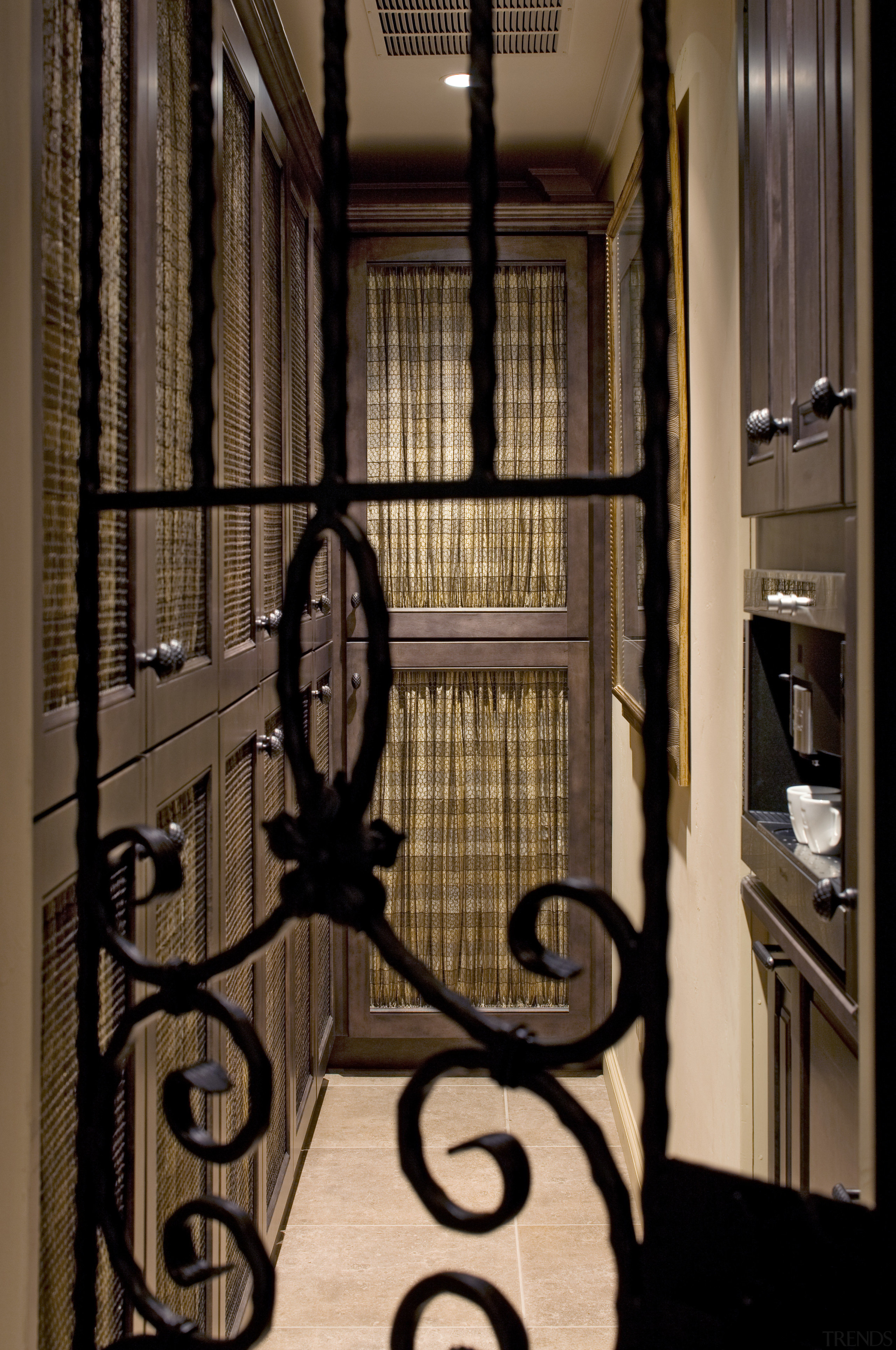 View of a traditional European-styled kitchen which a door, home, iron, window, brown, black