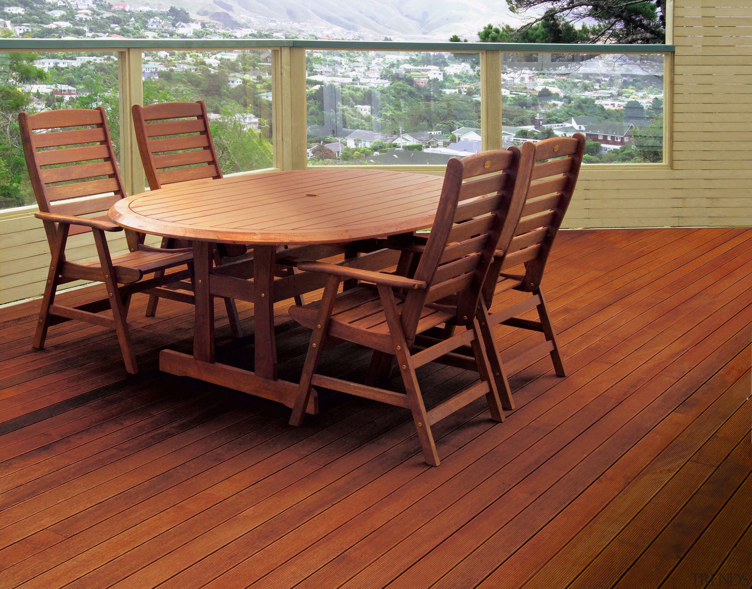 Outdoor patio area with timber decking, round timber chair, deck, floor, flooring, furniture, hardwood, laminate flooring, outdoor furniture, outdoor structure, patio, table, wood, wood flooring, wood stain, red