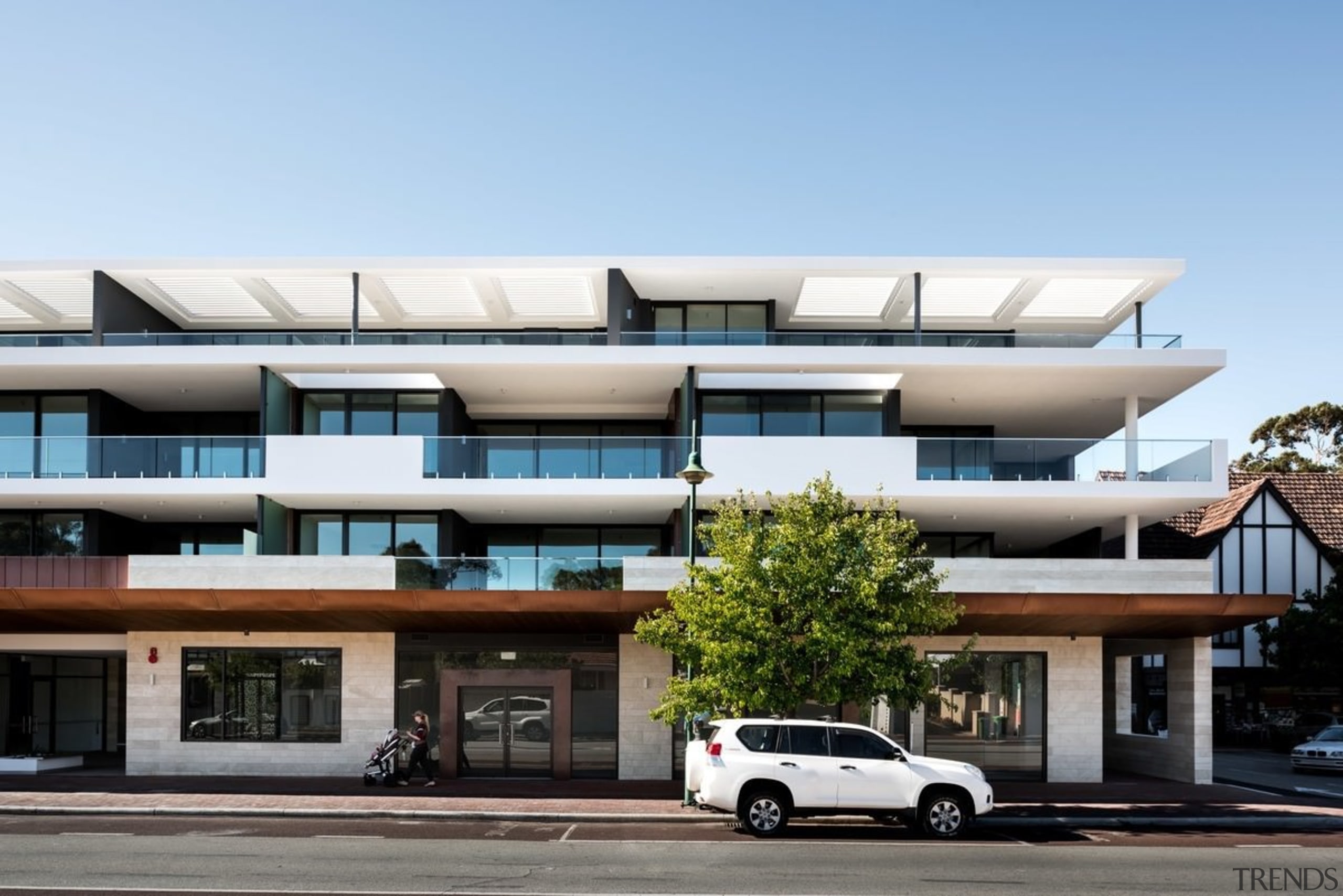 A view of the development during the day apartment, architecture, building, commercial building, condominium, corporate headquarters, elevation, facade, family car, house, luxury vehicle, metropolitan area, mixed use, property, real estate, residential area, teal