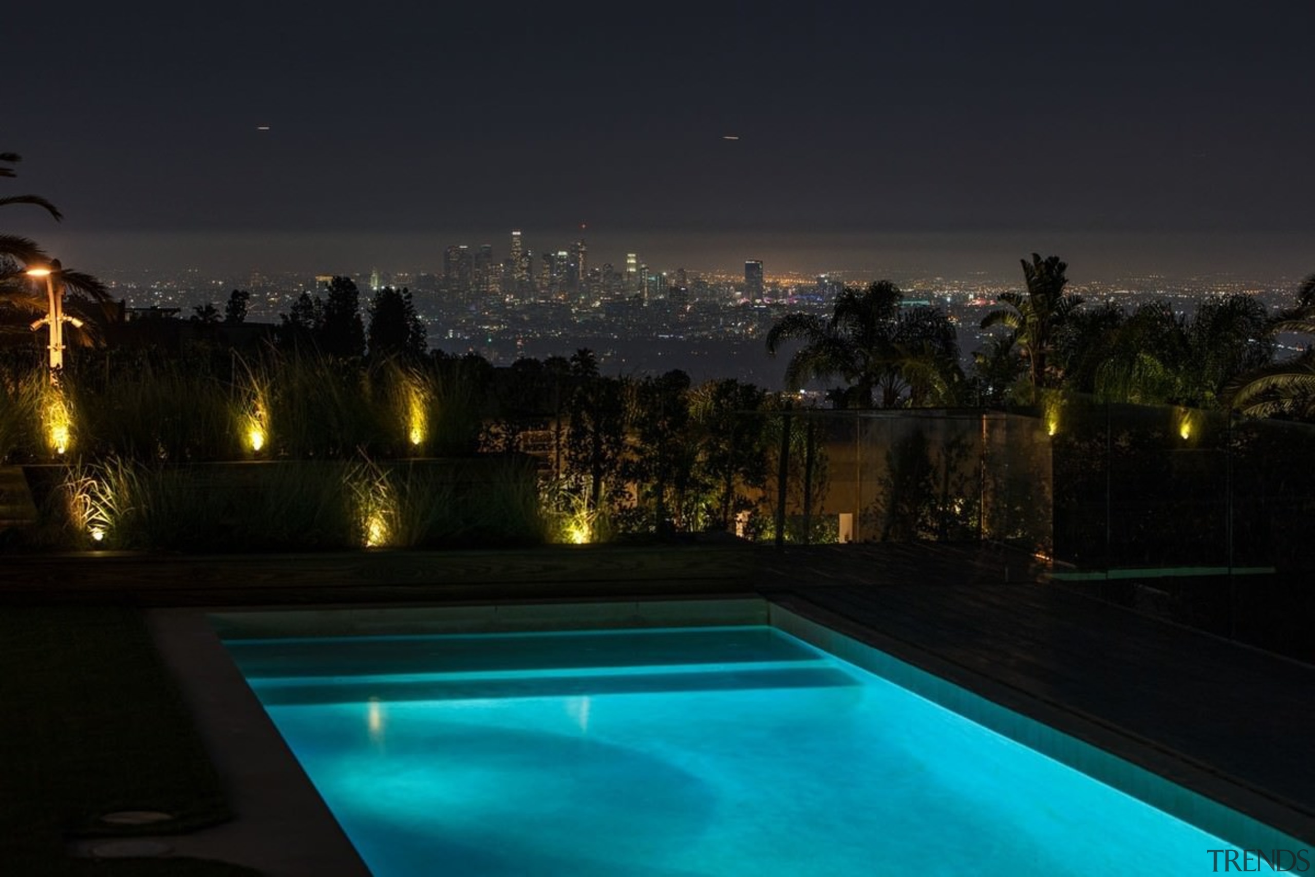 The city takes on a whole other quality estate, evening, landscape lighting, light, lighting, night, reflection, sky, swimming pool, water, black