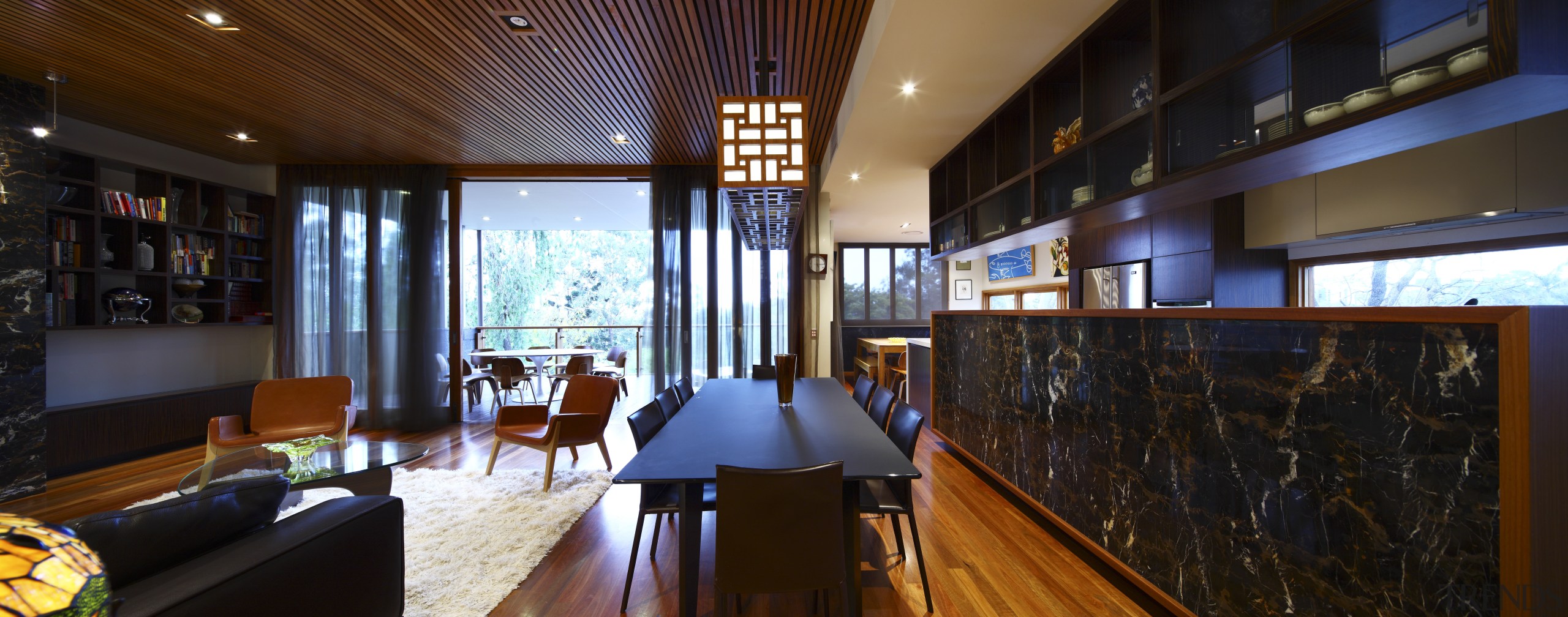 View of kitchen with wooden flooring, dark toned interior design, lobby, real estate, restaurant, black, brown