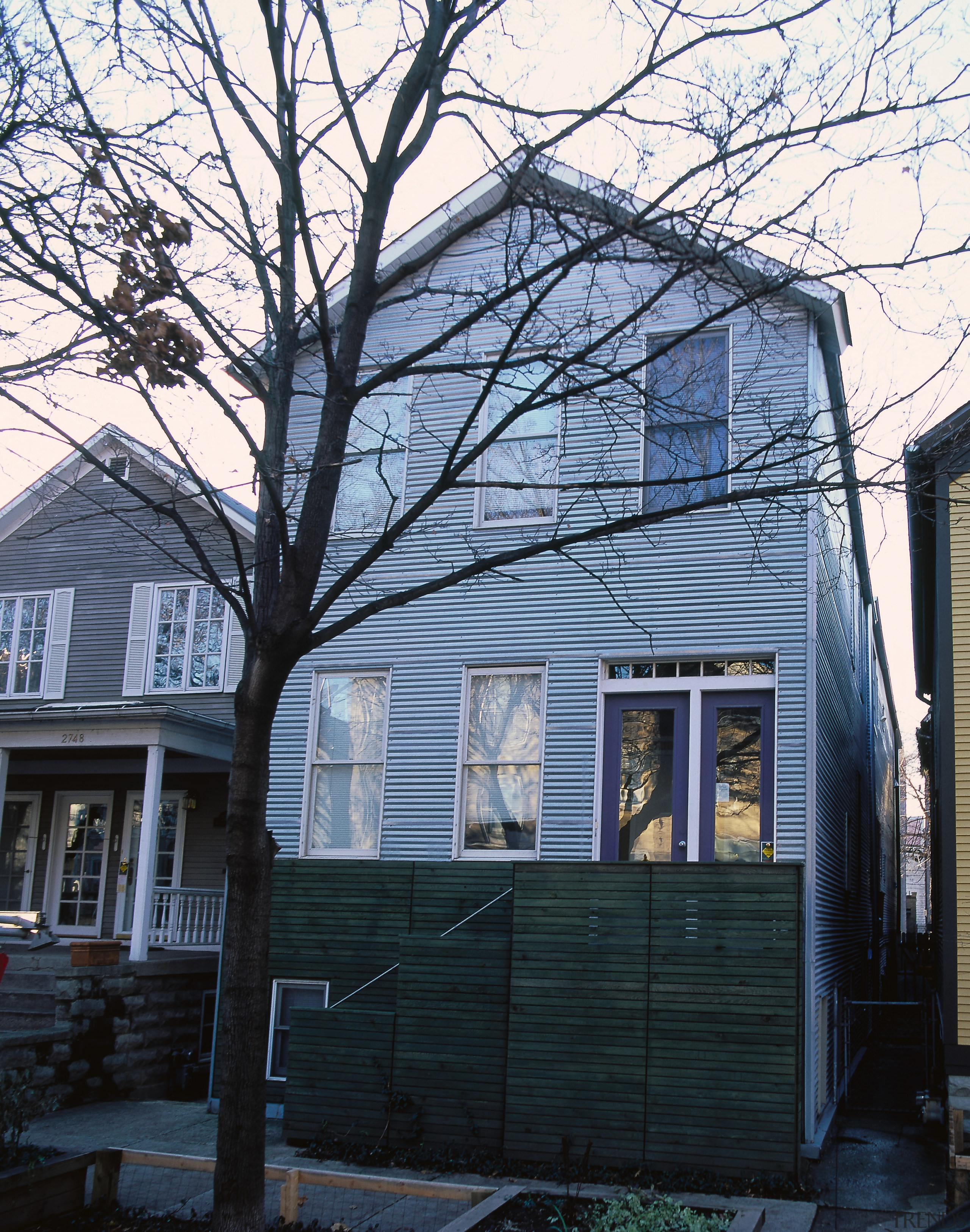 Exterior view of this home, wooden fence, trees, architecture, building, facade, home, house, neighbourhood, plant, real estate, residential area, roof, siding, suburb, tree, window, winter, wood, woody plant, black