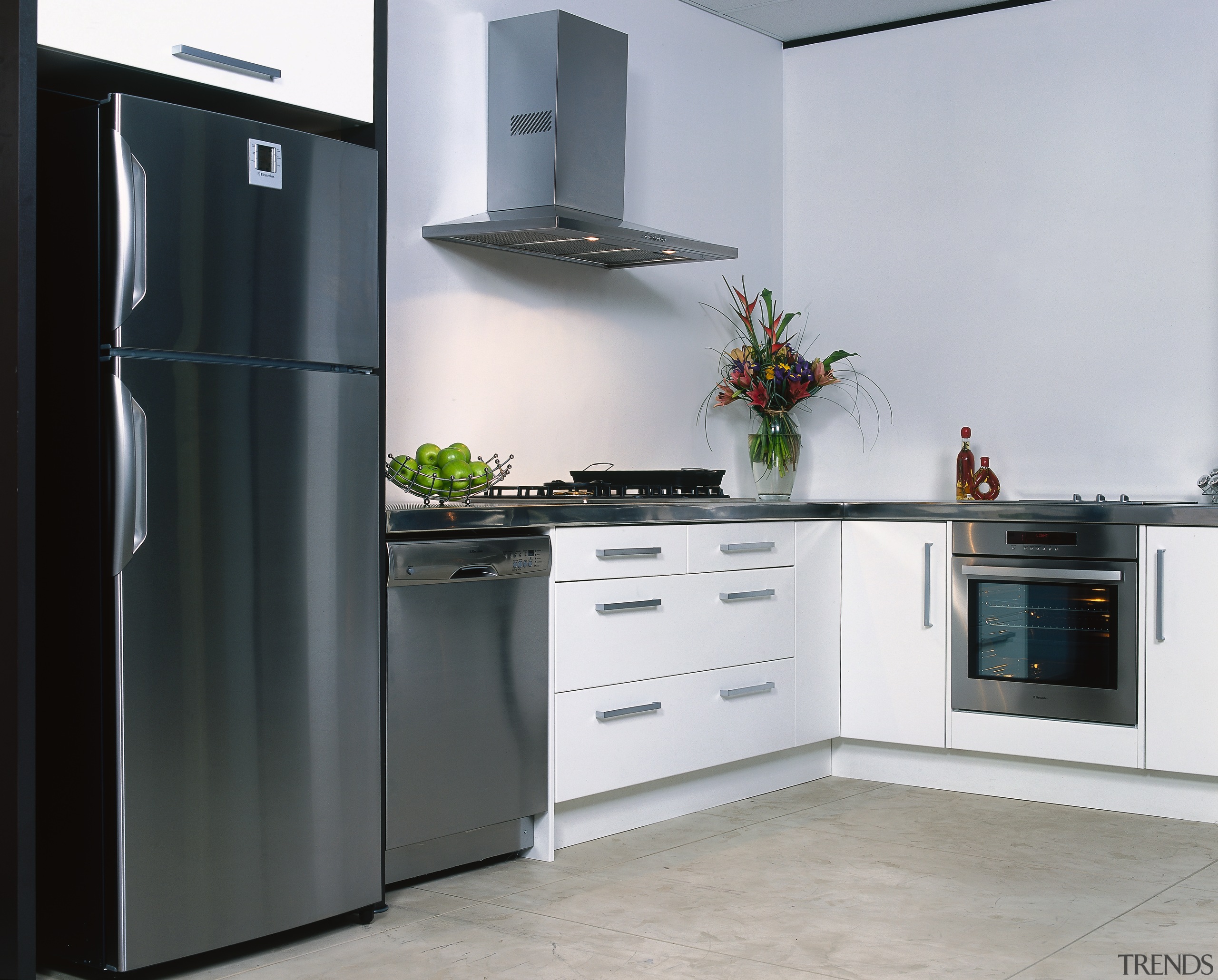 Kitchen with white cabinetry, stainless refrigerator, dishwasher, oven countertop, cuisine classique, home appliance, kitchen, kitchen appliance, kitchen stove, major appliance, product design, refrigerator, gray, black