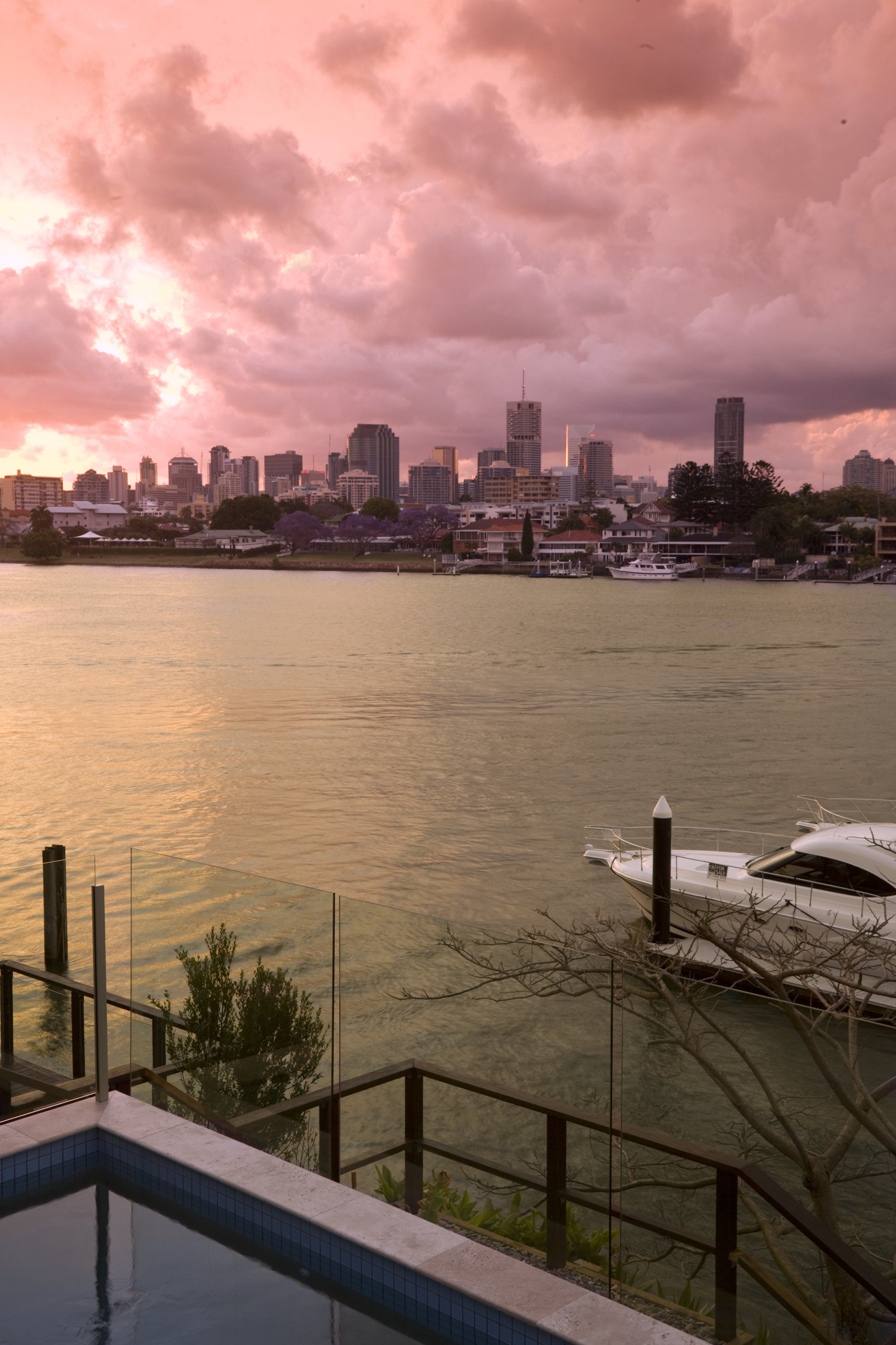 View of the Norman Reach development which is city, cityscape, cloud, dawn, daytime, dusk, evening, horizon, meteorological phenomenon, morning, reflection, river, sea, sky, skyline, skyscraper, sunrise, sunset, urban area, water, pink, brown