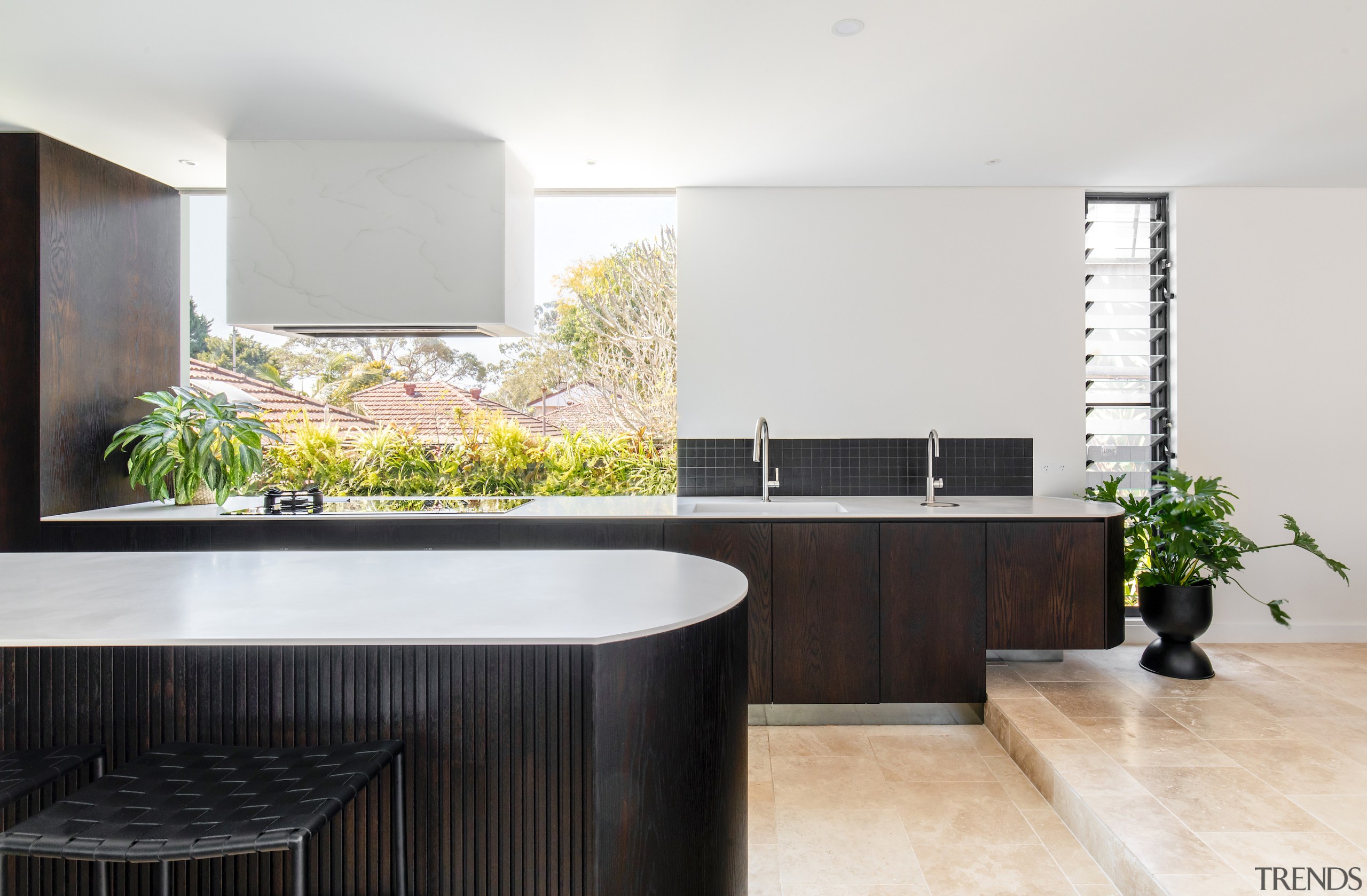 A giant window splashback floods the kitchen in 