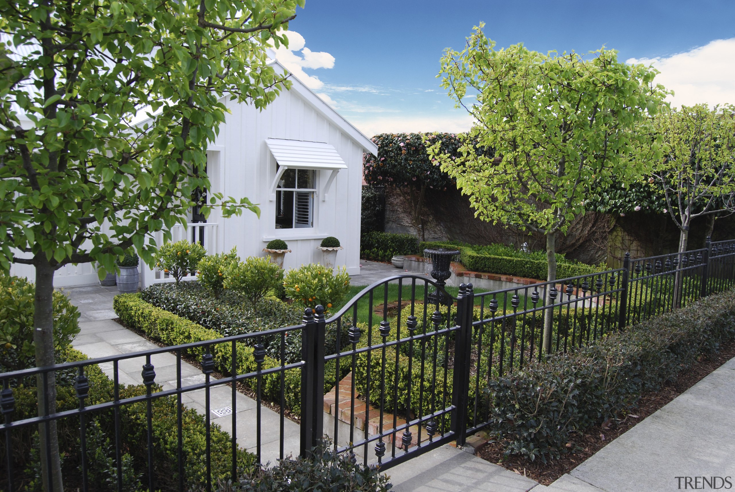 View of formal garden designed by Michael Mansvelt cottage, estate, facade, fence, home, house, neighbourhood, outdoor structure, property, real estate, residential area, tree, black