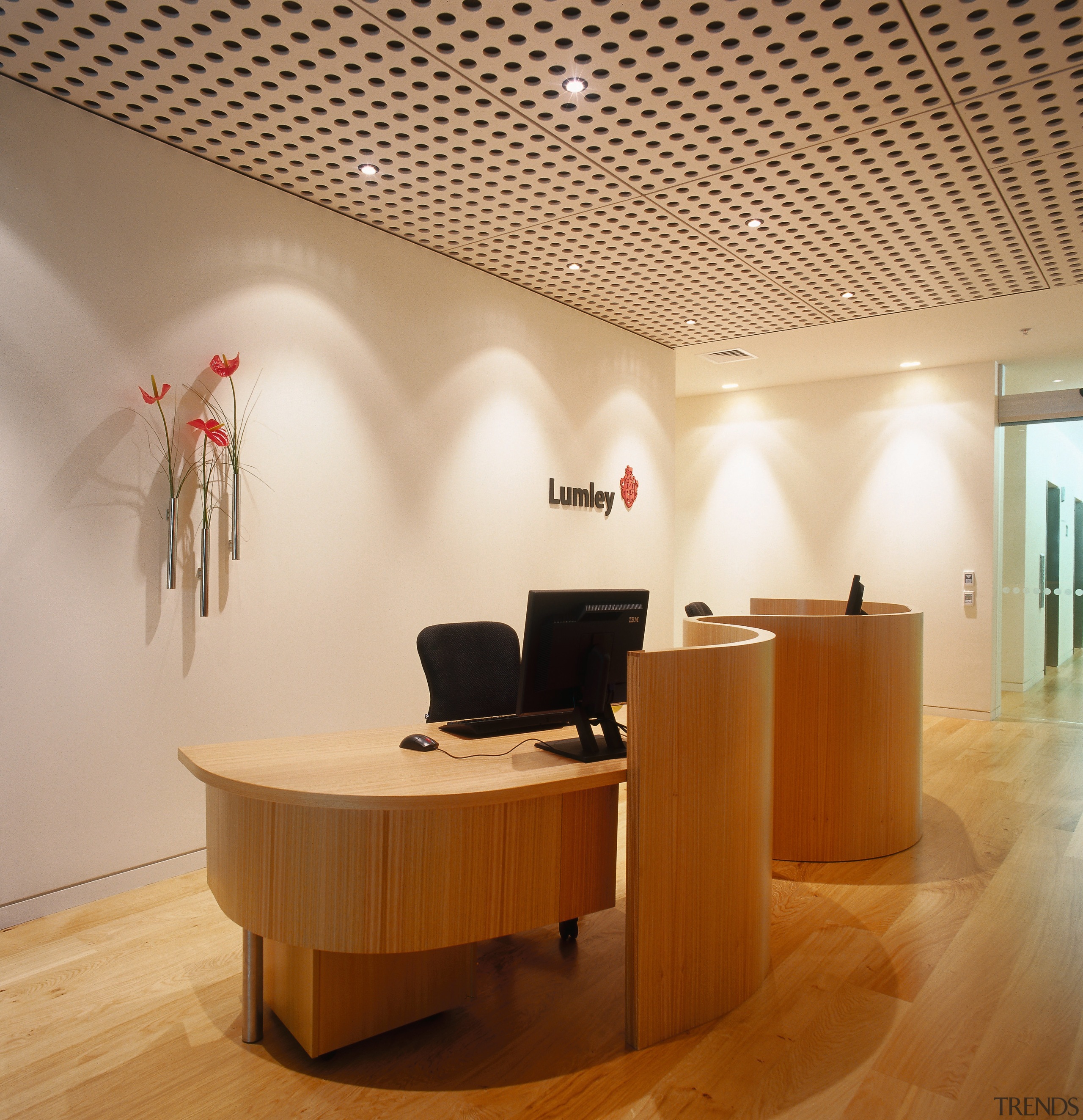 A view of the signage placed about the ceiling, desk, floor, flooring, furniture, interior design, lobby, office, product design, table, wood, wood flooring, orange, brown